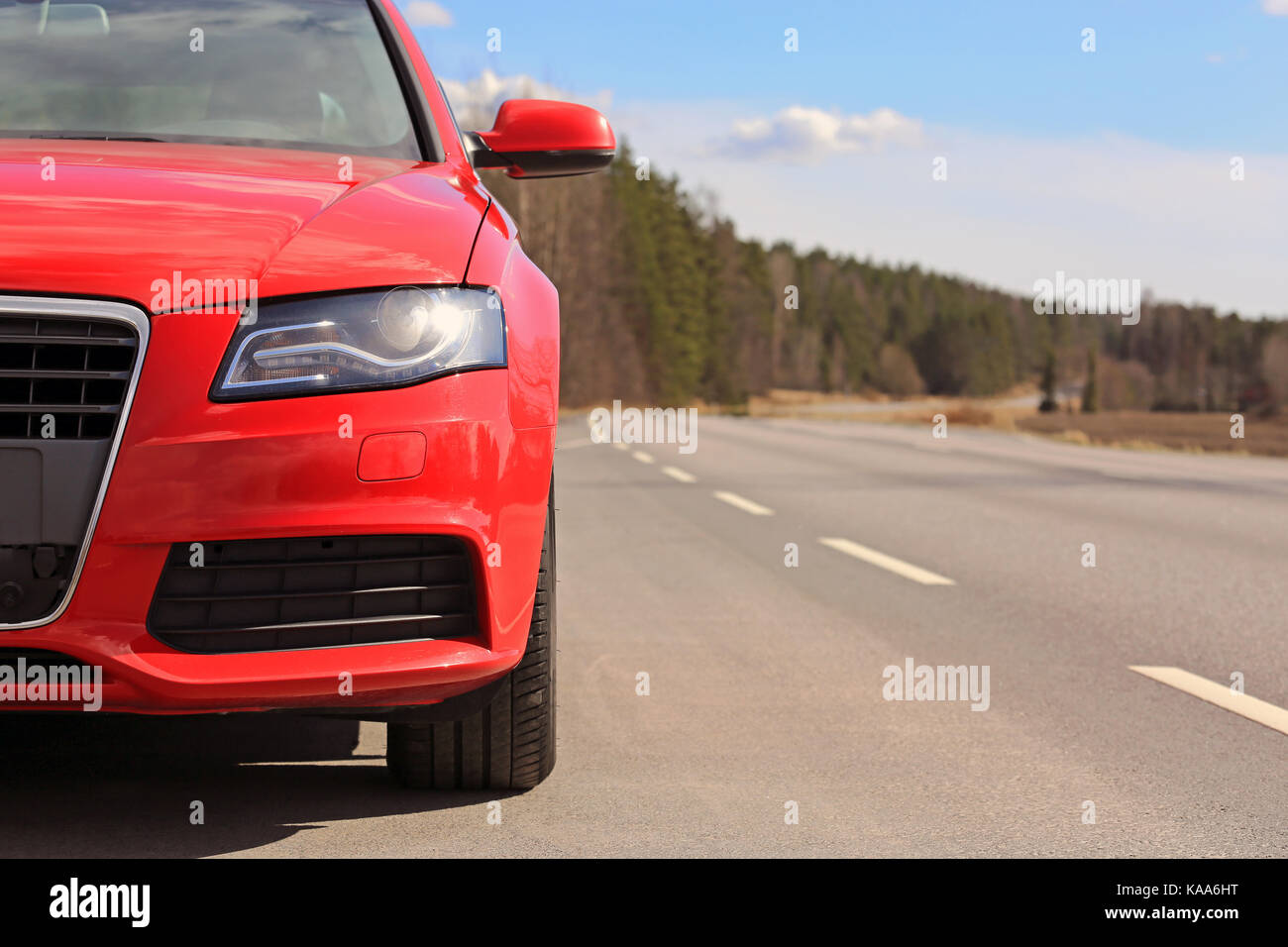 Detail of beautiful red car on side of the road on a sunny day of spring. Stock Photo