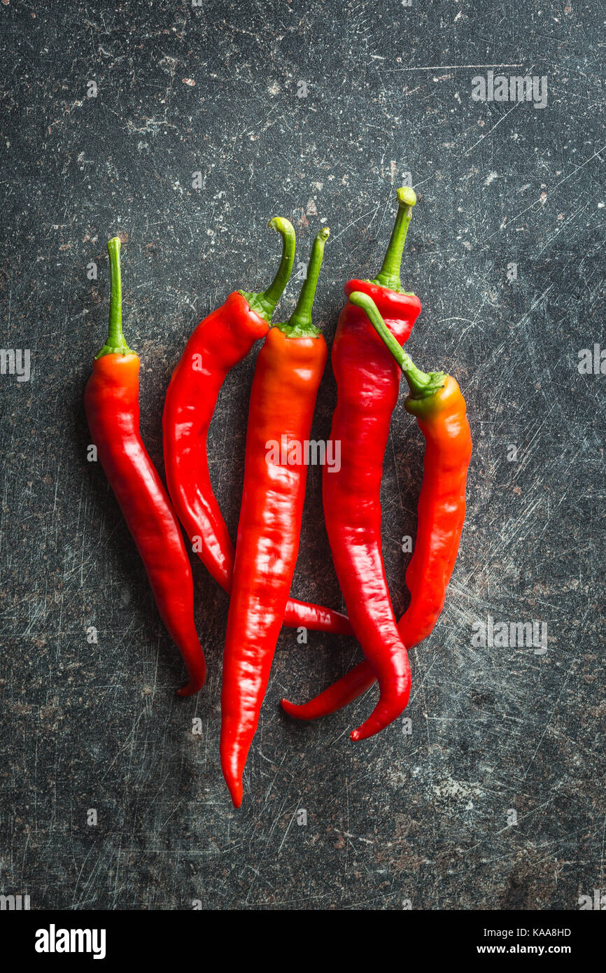 Red chili peppers on kitchen table Stock Photo - Alamy