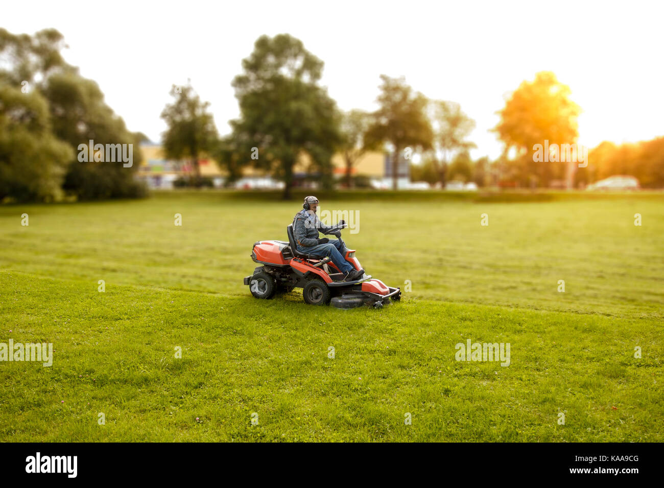 man drives a lawnmower Stock Photo