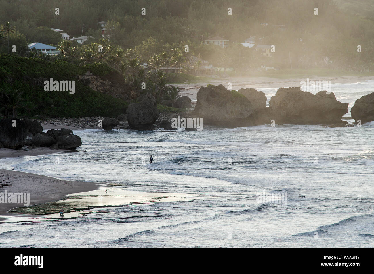 Visitors bathing in rock pools on Bathsheba beach also known as the 'Soup Bowl' - east coast of Barbados Stock Photo