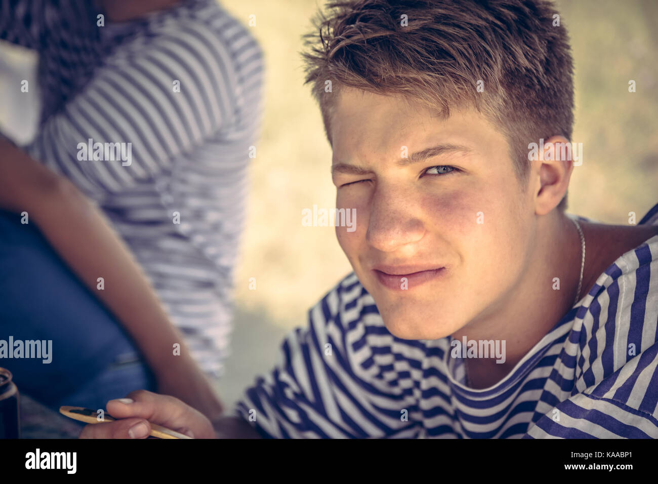 Handsome  teenager boy  winking portrait in summer camp Stock Photo