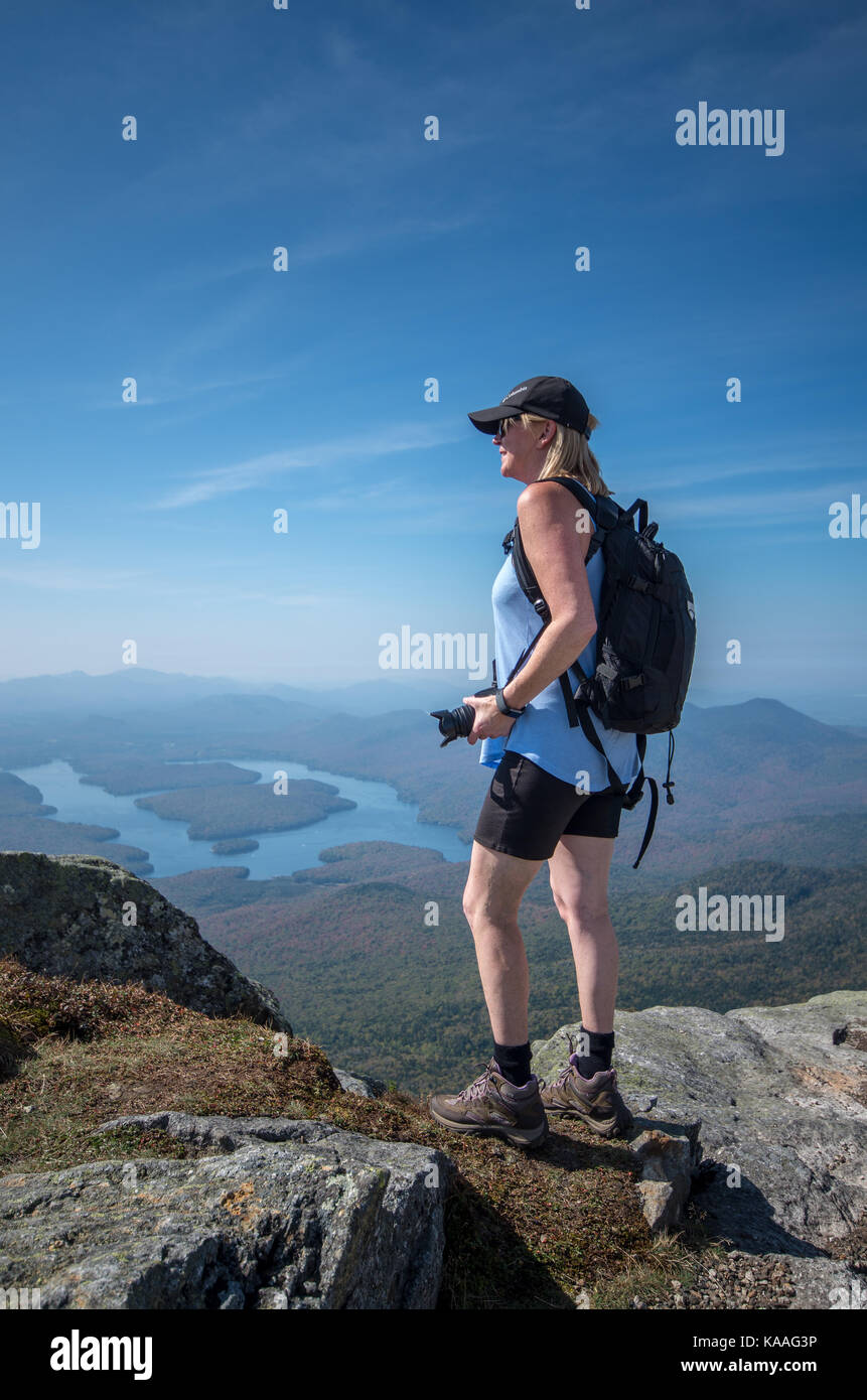 female hiker enjoying the view from the summit of Whiteface Mountain Stock Photo