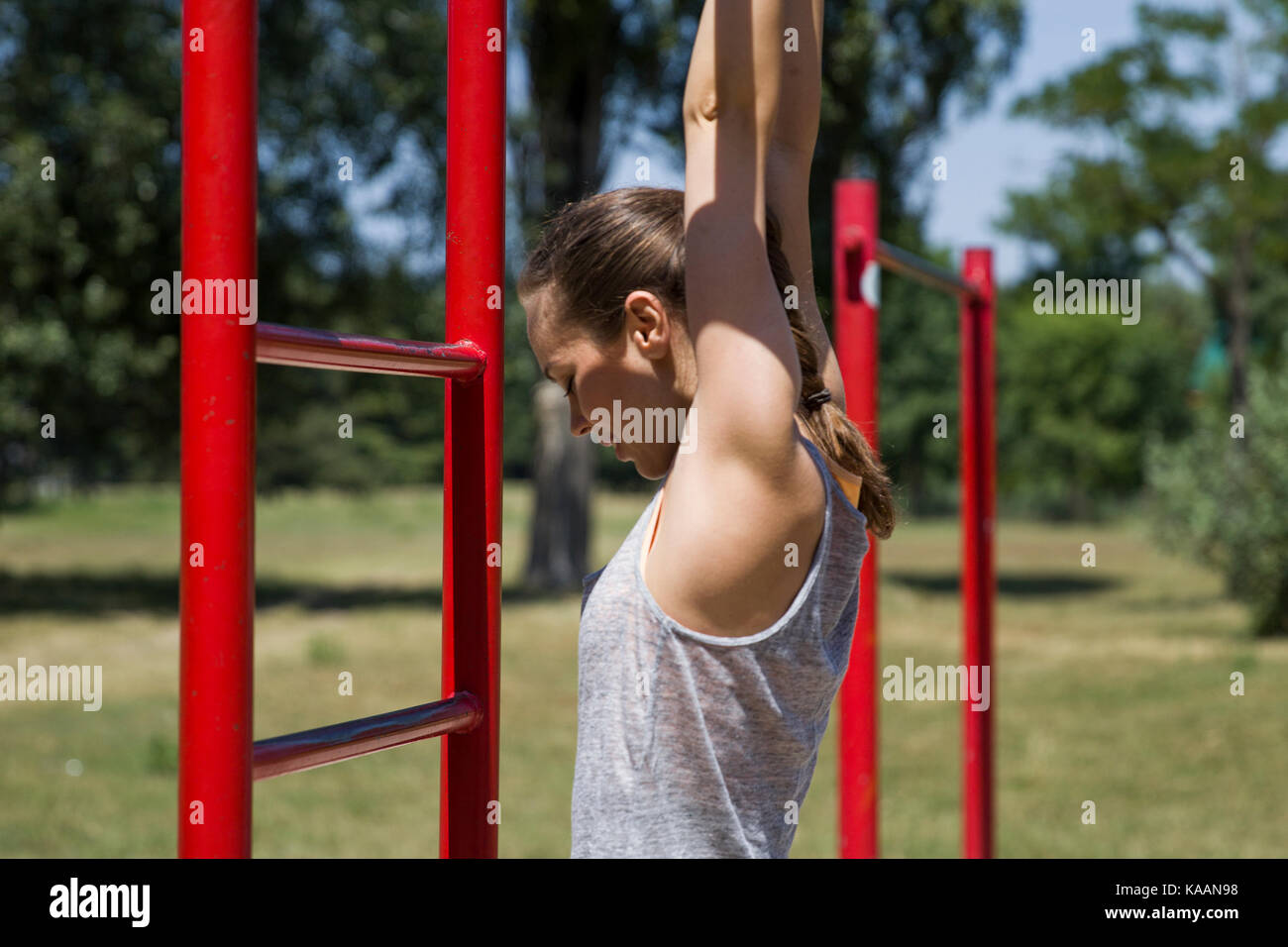 Strong yooung woman having workout in the park Stock Photo - Alamy