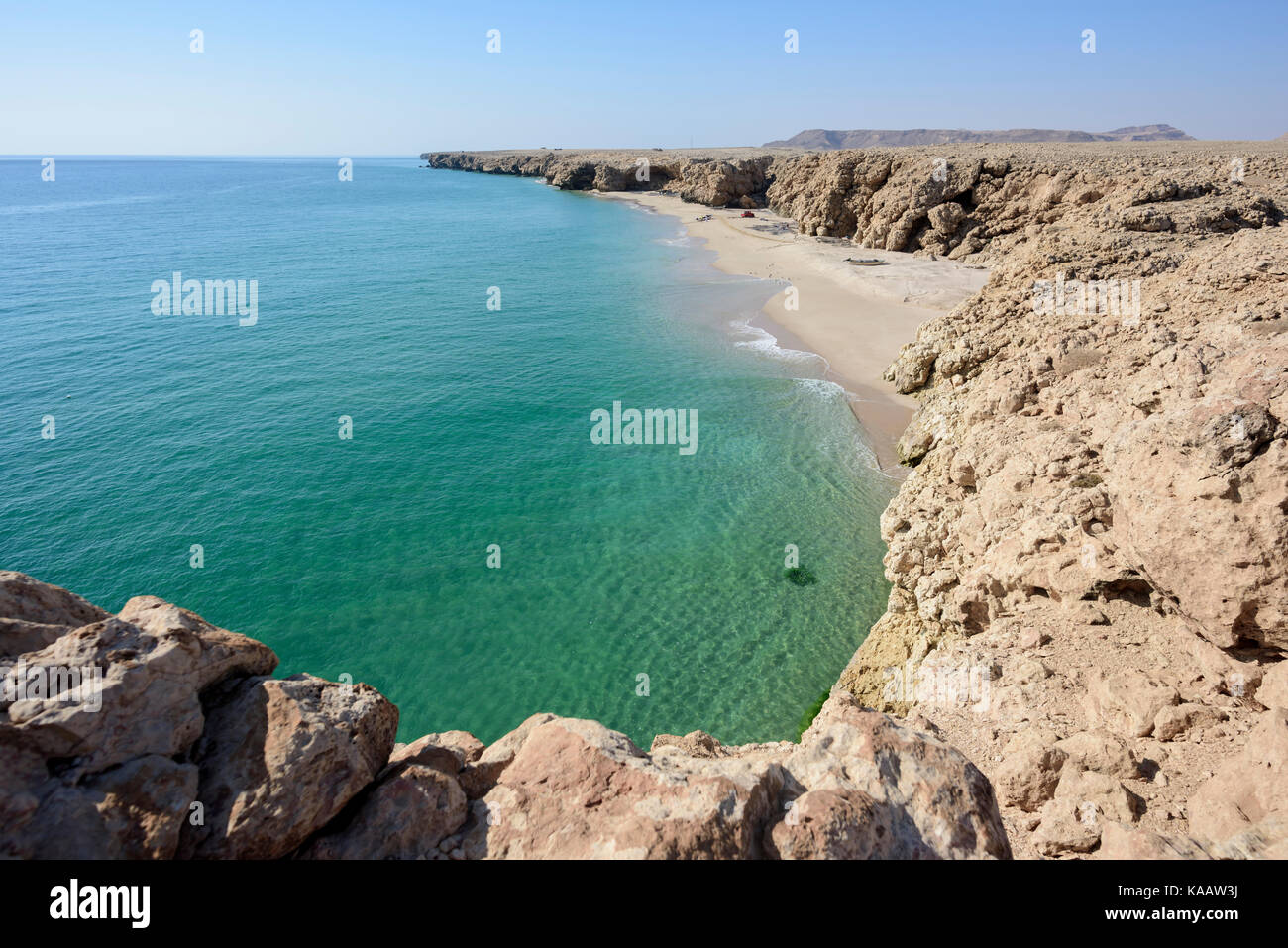 Wild beach at the coast of Ras Al Jinz with calm ocean and blue sky, Sultanate of Oman. Stock Photo