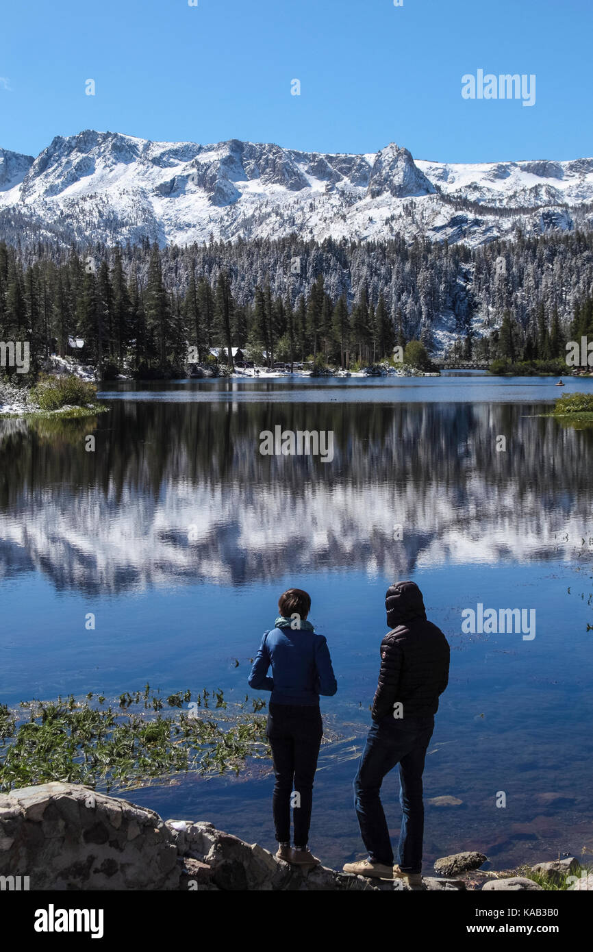 Tourists see mirror reflection at Twin Lakes  at Mammoth Lakes Basin in Mammoth Lakes in the Eastern Sierra of California Stock Photo