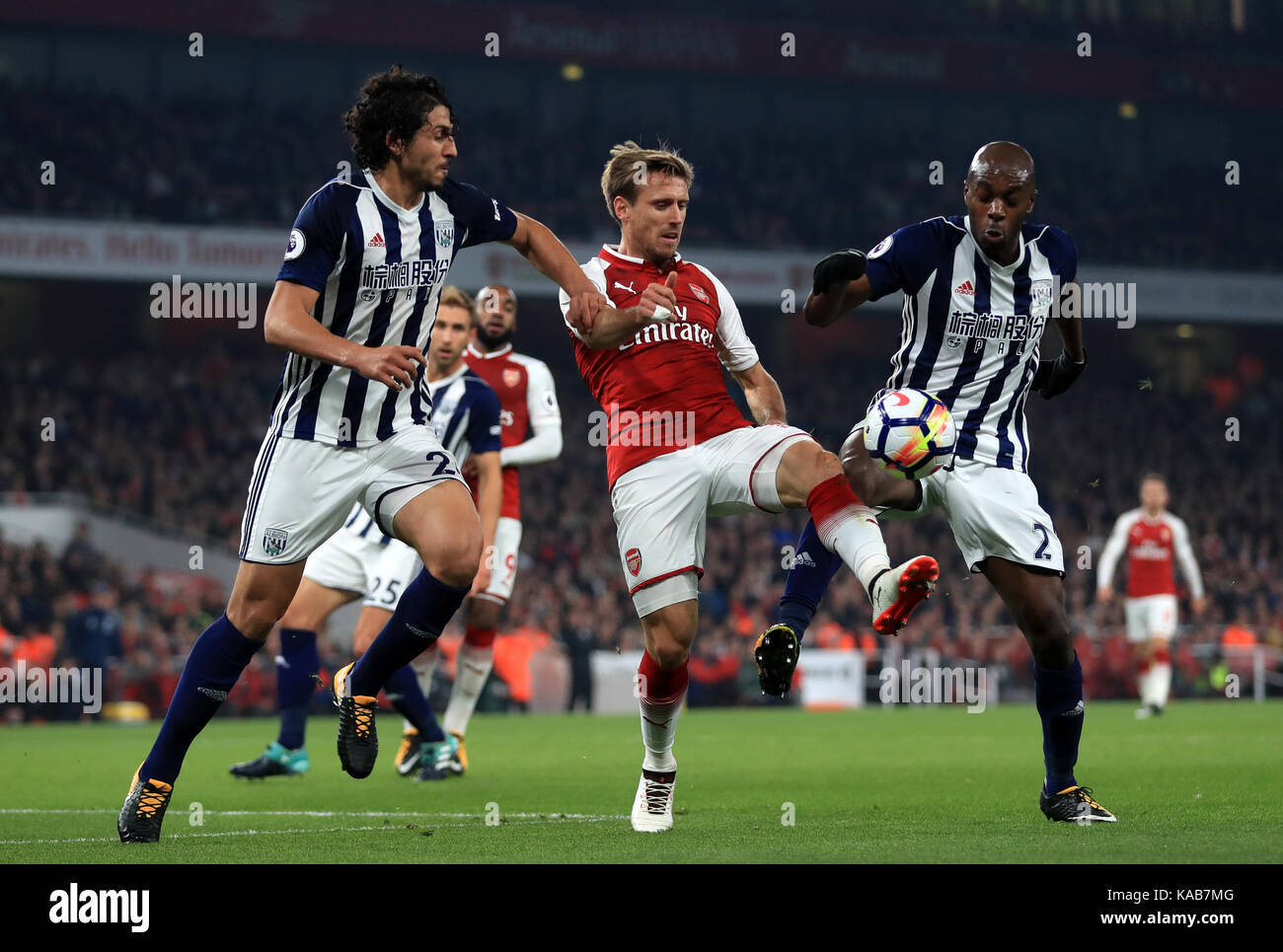 Arsenal's Nacho Monreal (centre) takes on West Bromwich Albion's Allan Nyom (right) and Ahmed Hegazy during the Premier League match at the Emirates Stadium, London. Stock Photo