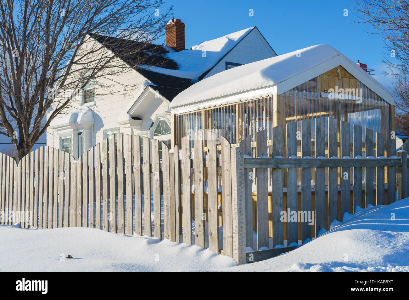 Small Wooden Home Greenhouse In A Snow Covered Backyard Stock