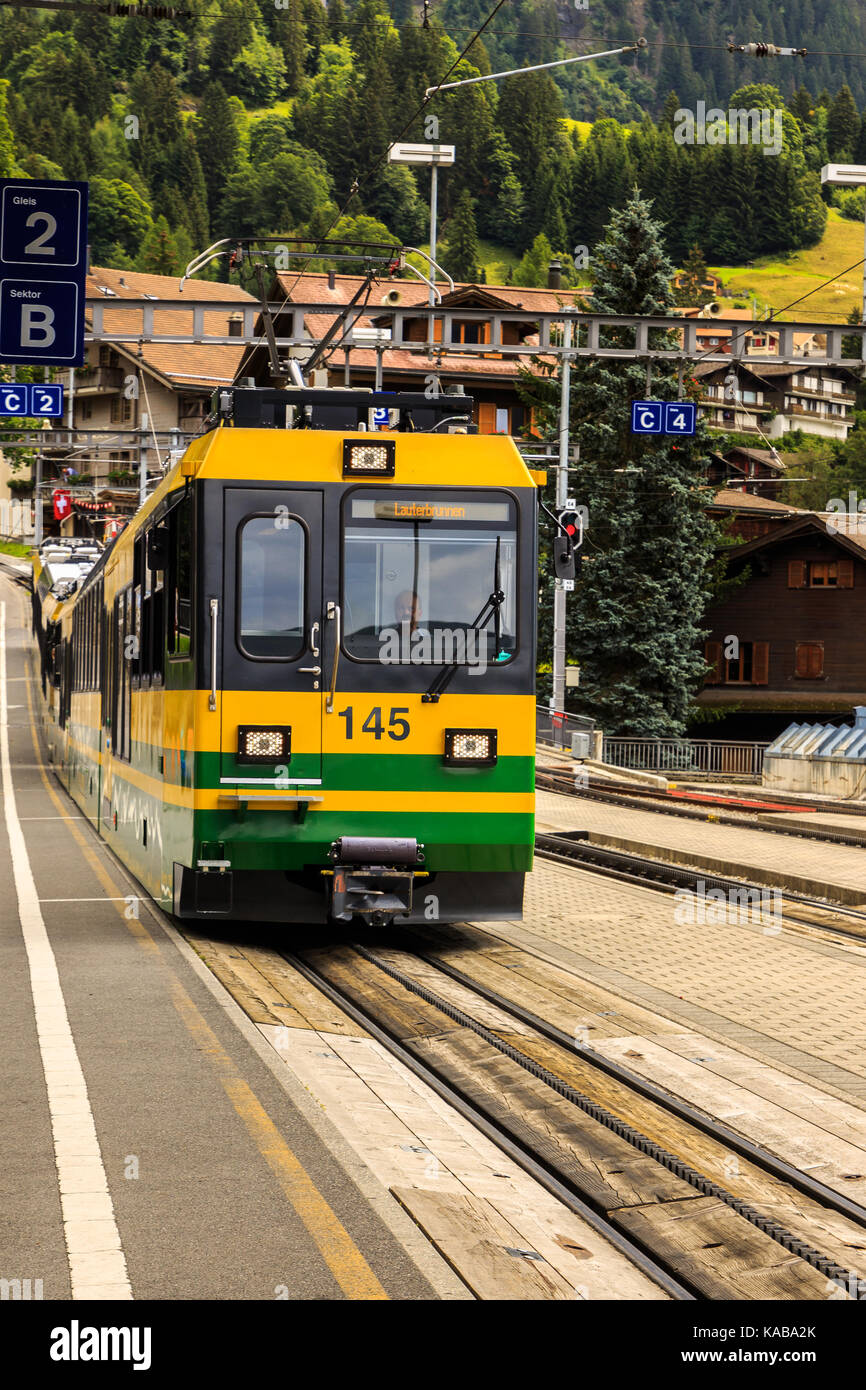 Wengen, Bernese Oberland, Switzerland - JULY 31, 2017 : Train of the Wengernalpbahn from Kleine Scheidegg to Lauterbrunnen in railwaystation in car-fr Stock Photo