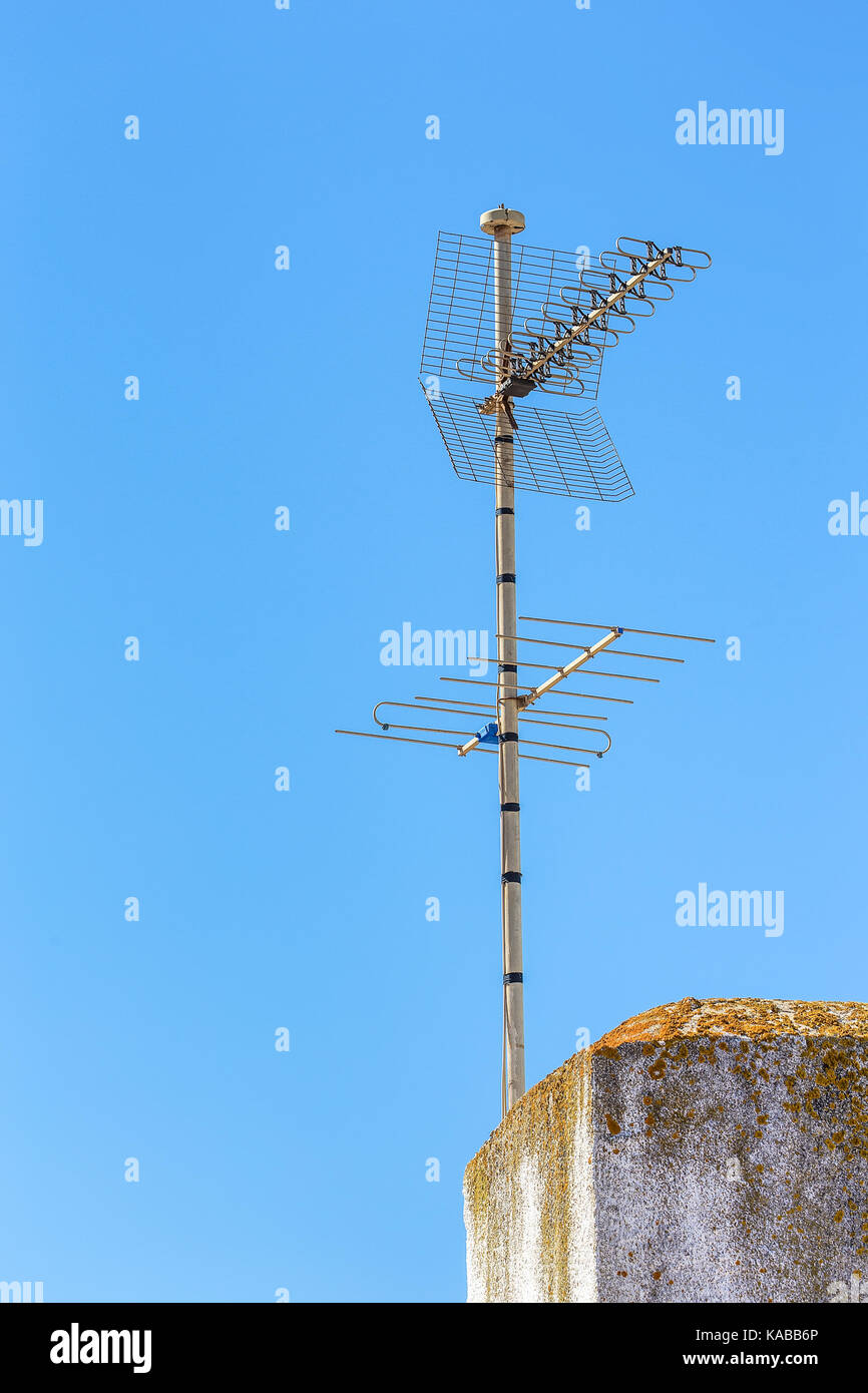 TV and Radio antenna at chimney in blue sky Stock Photo