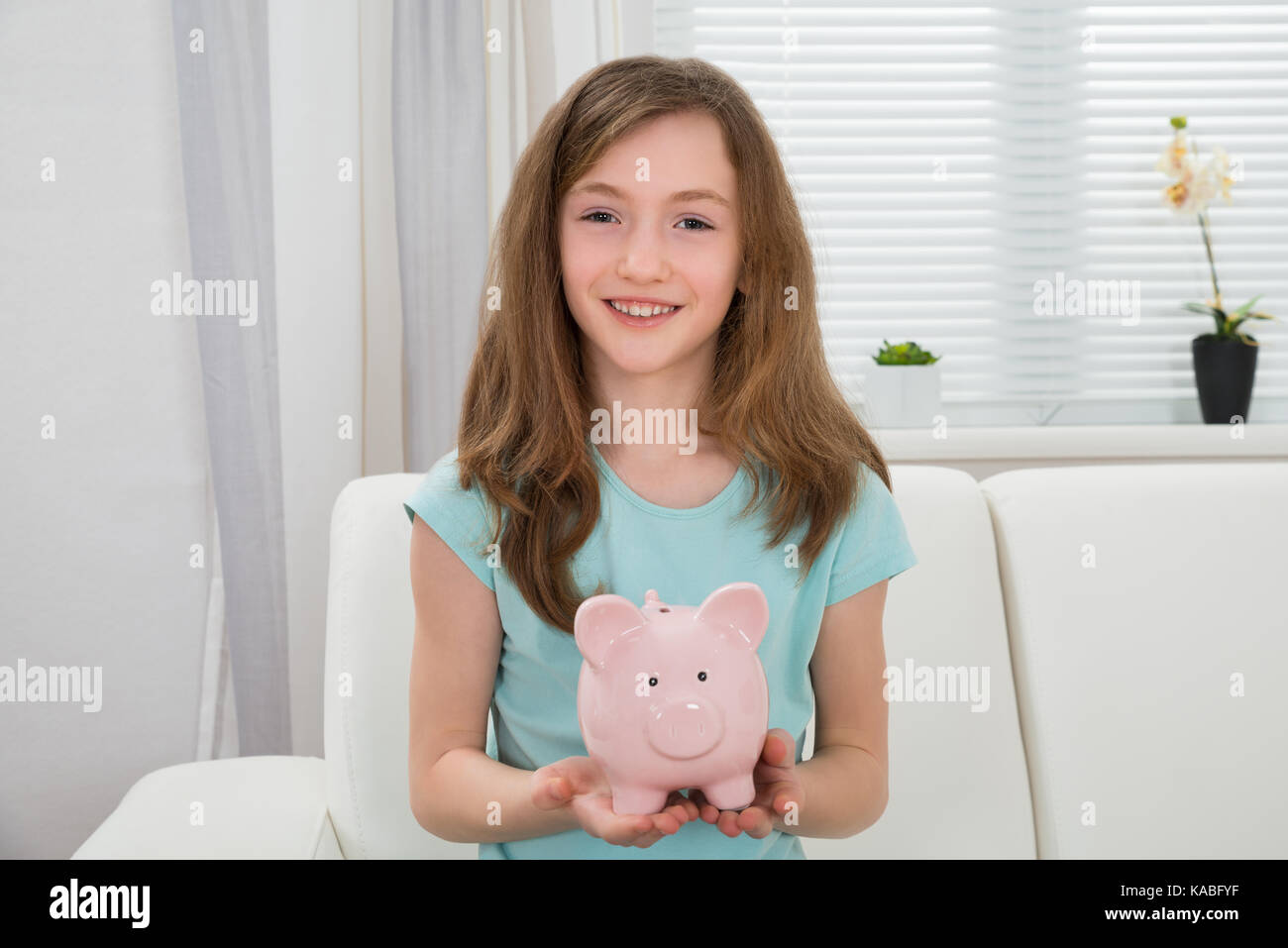 Portrait Of Cute Girl Holding Pink Piggy Bank In Hands Stock Photo - Alamy