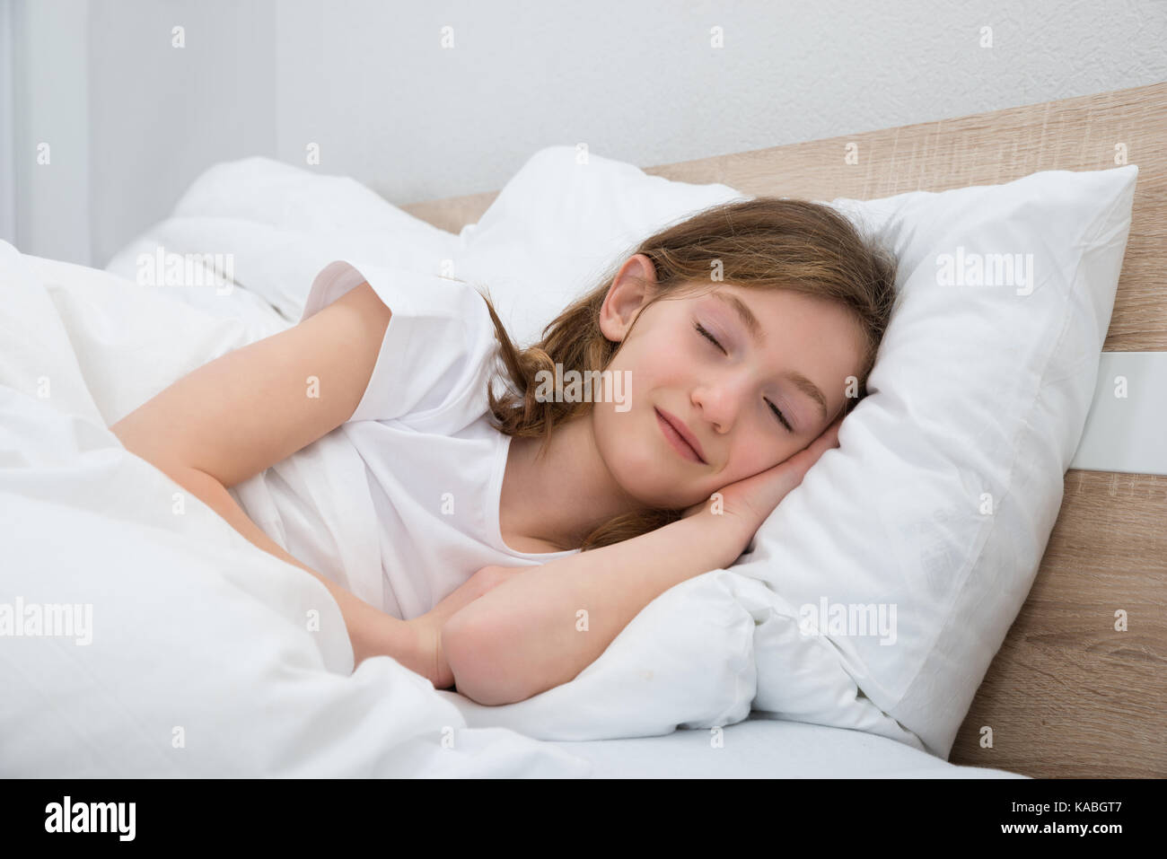 Cute Girl Sleeping With White Blanket In Bed Stock Photo - Alamy