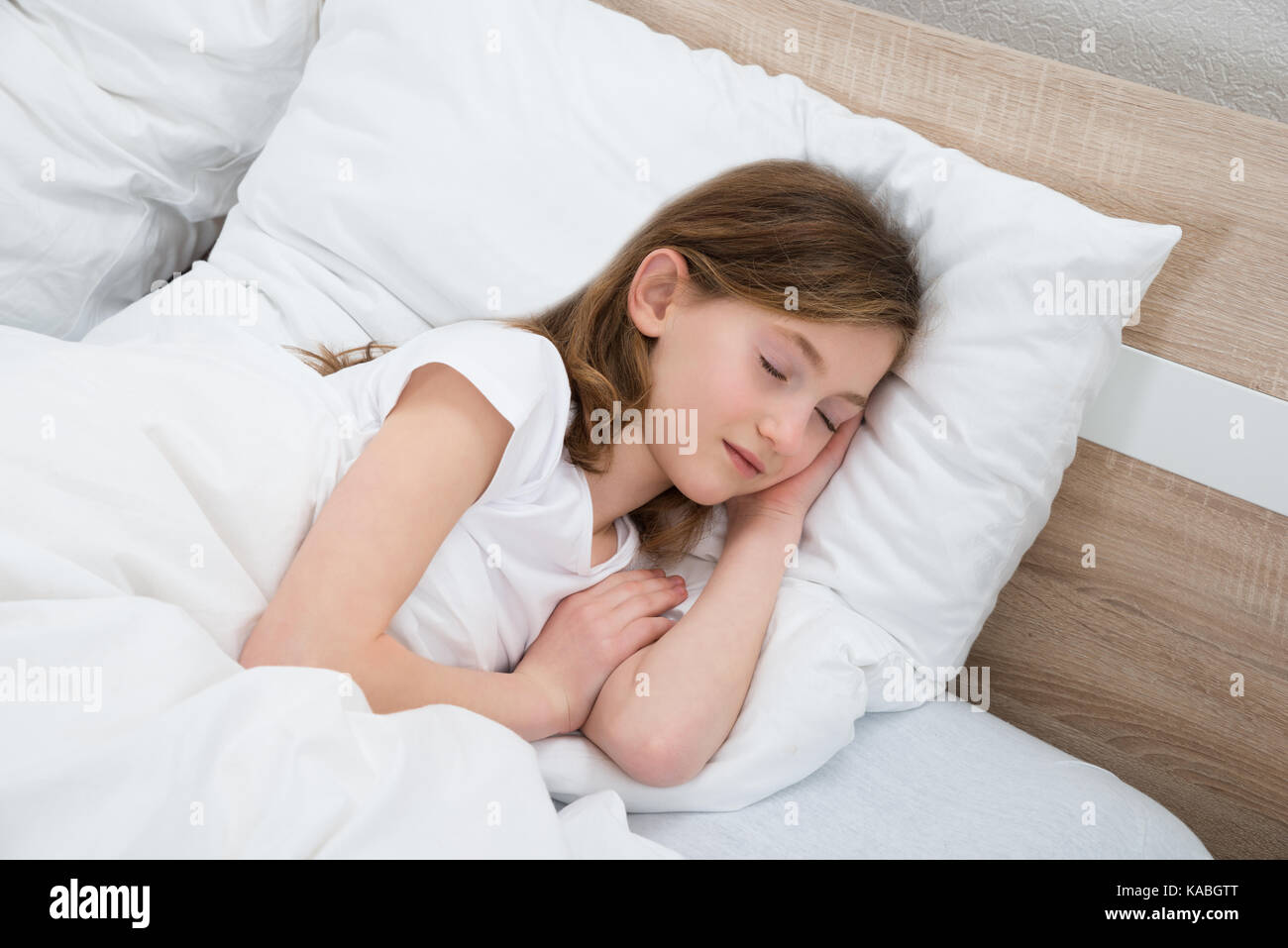 Cute Girl Sleeping With White Blanket In Bed Stock Photo - Alamy