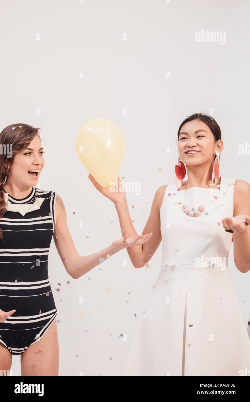 Two girls playing balloons hi-res stock photography and images - Alamy