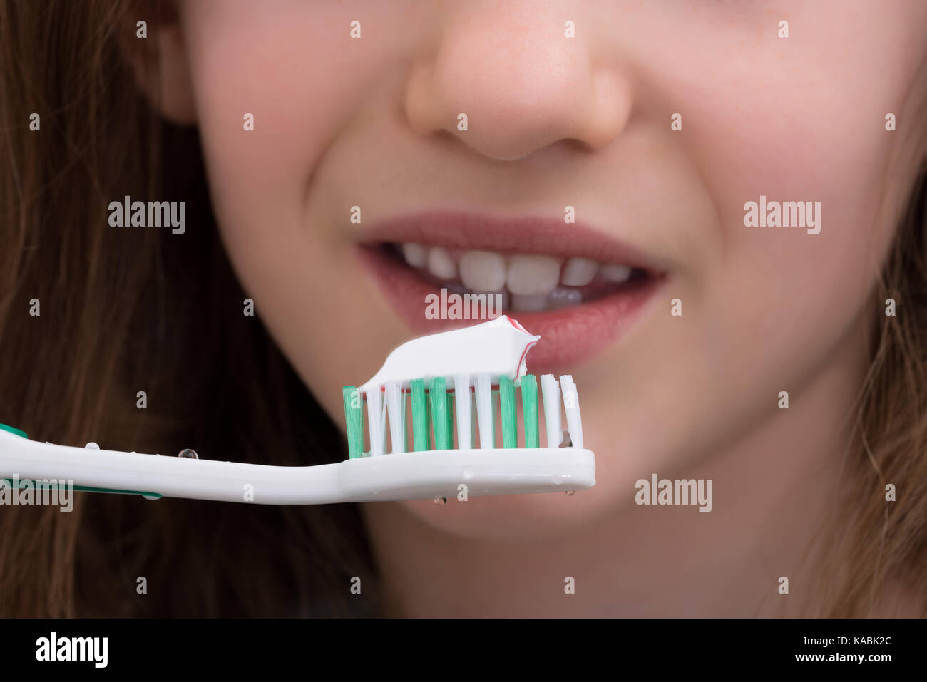 Closeup Of Girl Brushing Teeth With Toothbrush And Toothpaste Stock