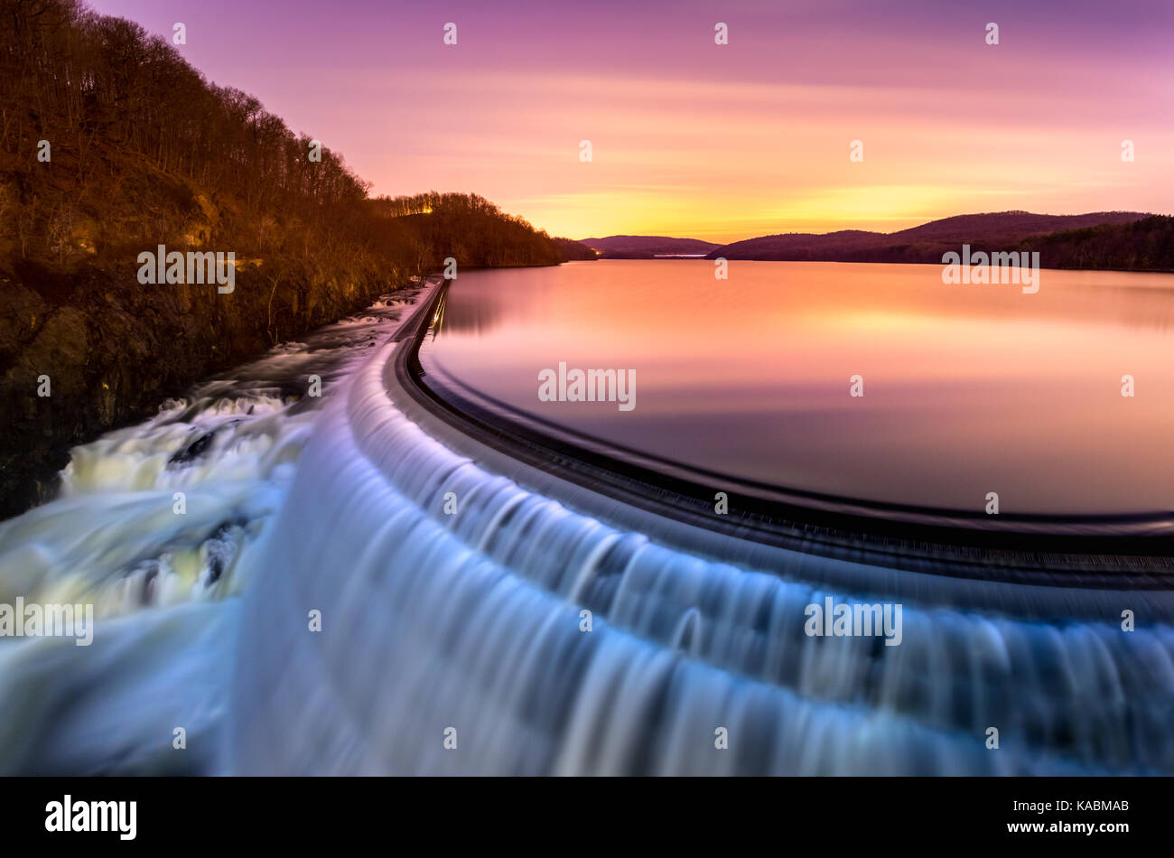 Sunrise over Croton Dam, NY and its stepped spillway waterfall. A very long exposure and the natural motion blur creates an artistic smooth and silky  Stock Photo