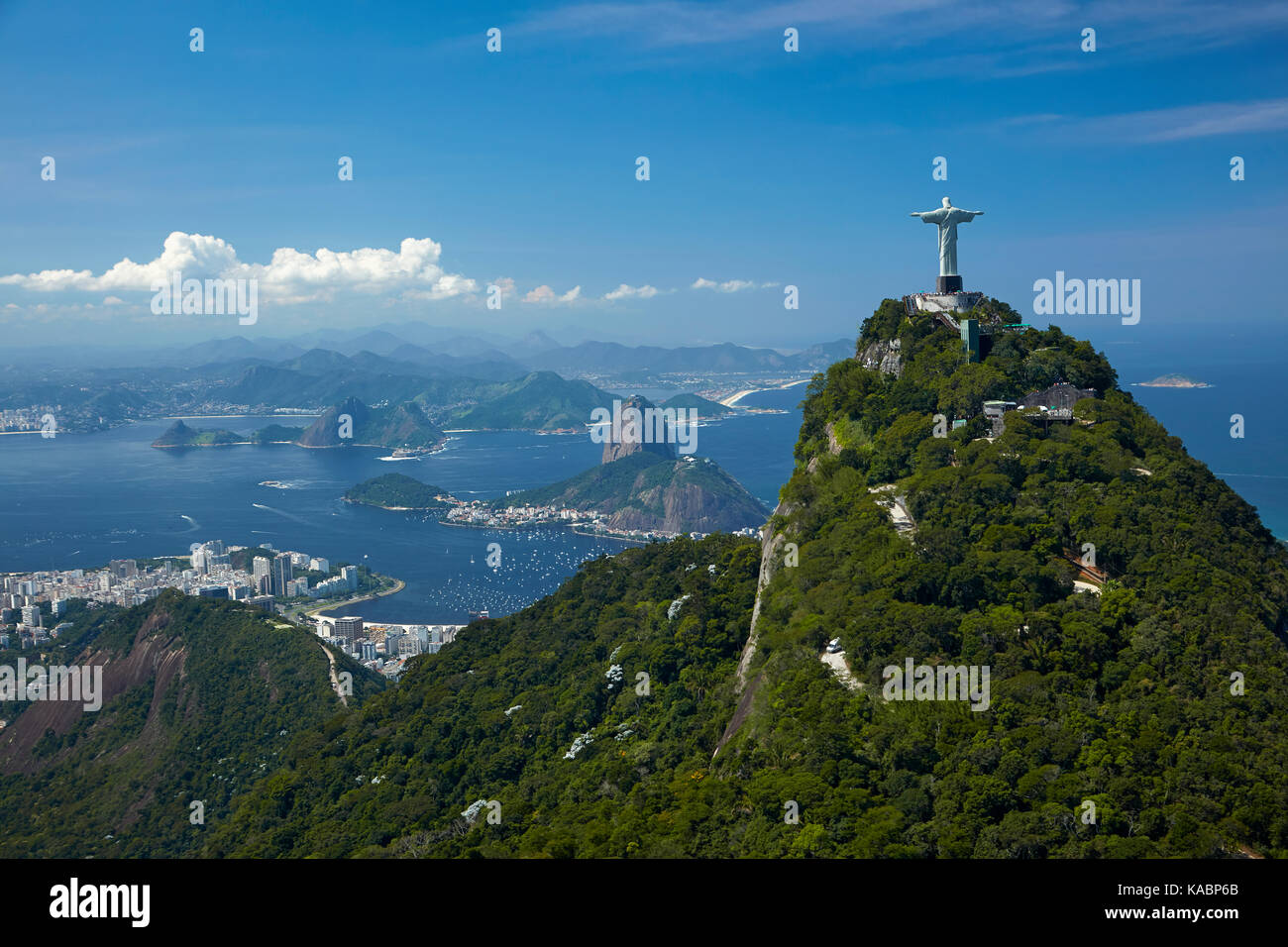 Christ the Redeemer statue atop Corcovado, and Sugarloaf Mountain, Rio de Janeiro, Brazil, South America - aerial Stock Photo