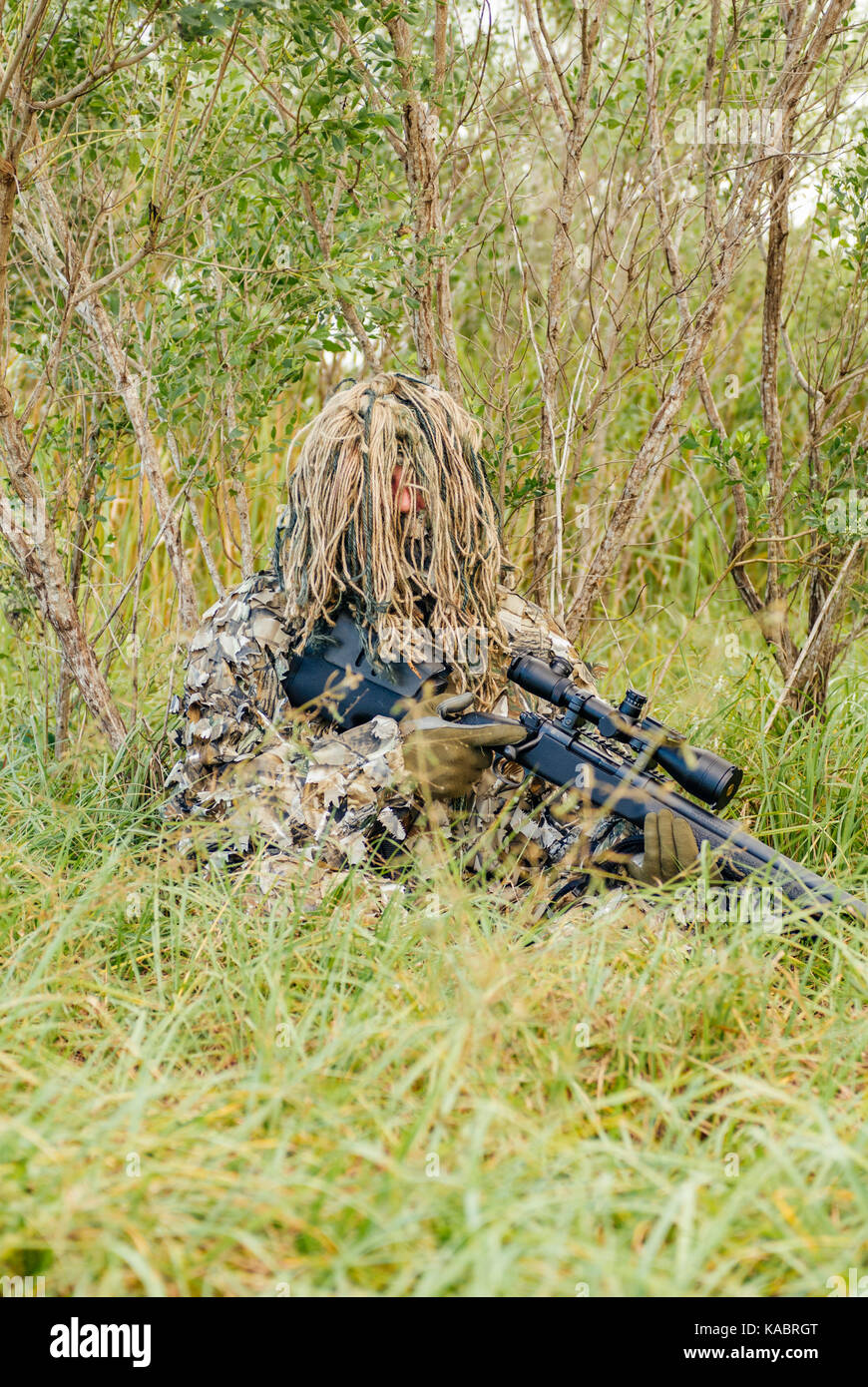 Law Enforcement Swat Sniper In A Ghillie Suit Crouched In