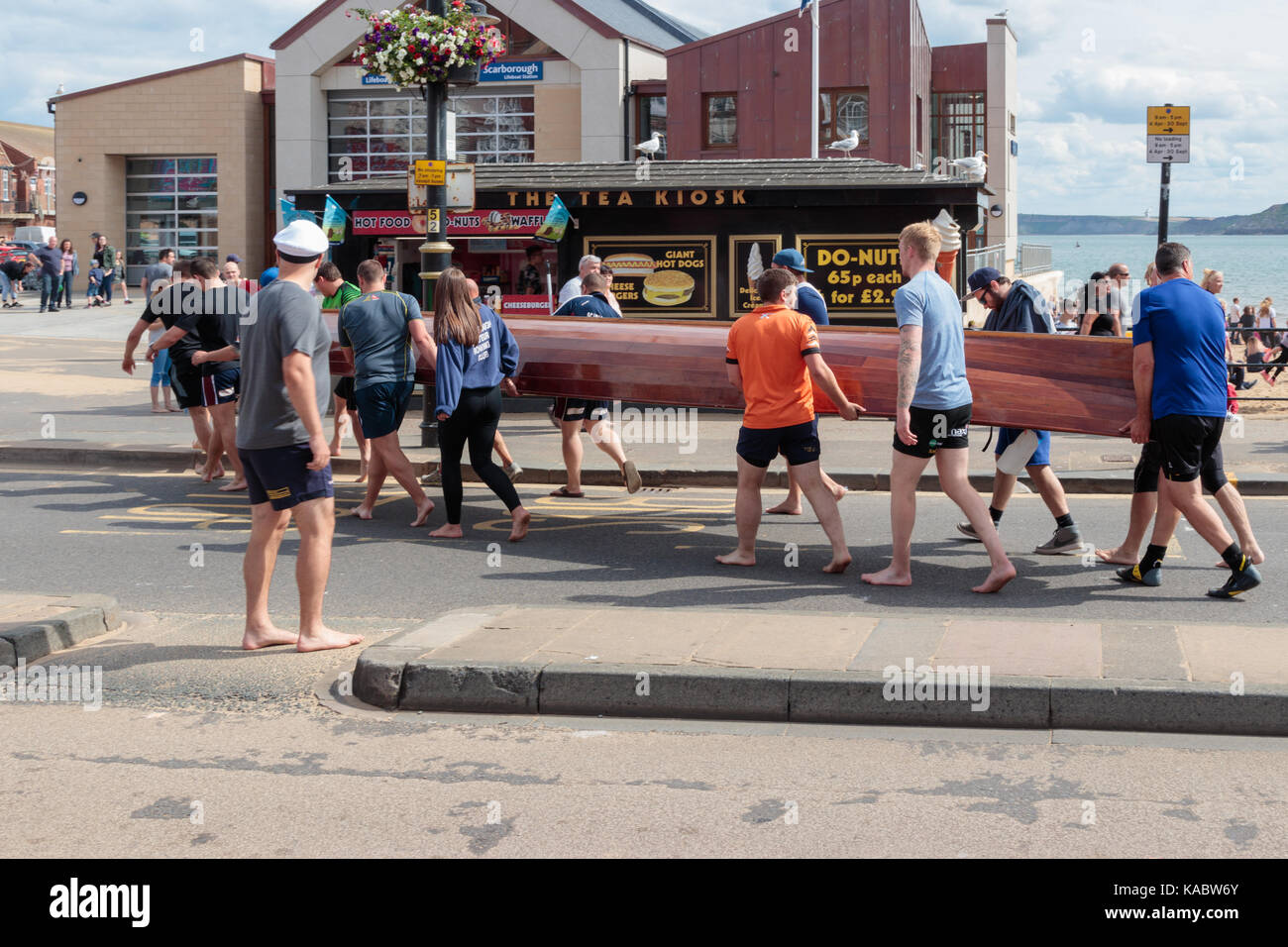 Scarborough Amateur Rowing Club launch one of their boats, carrying it