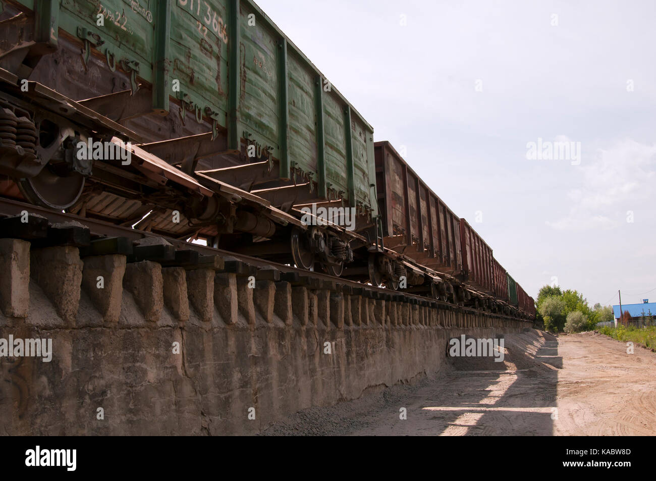Railway truck parked at the station waiting for unloading Stock Photo