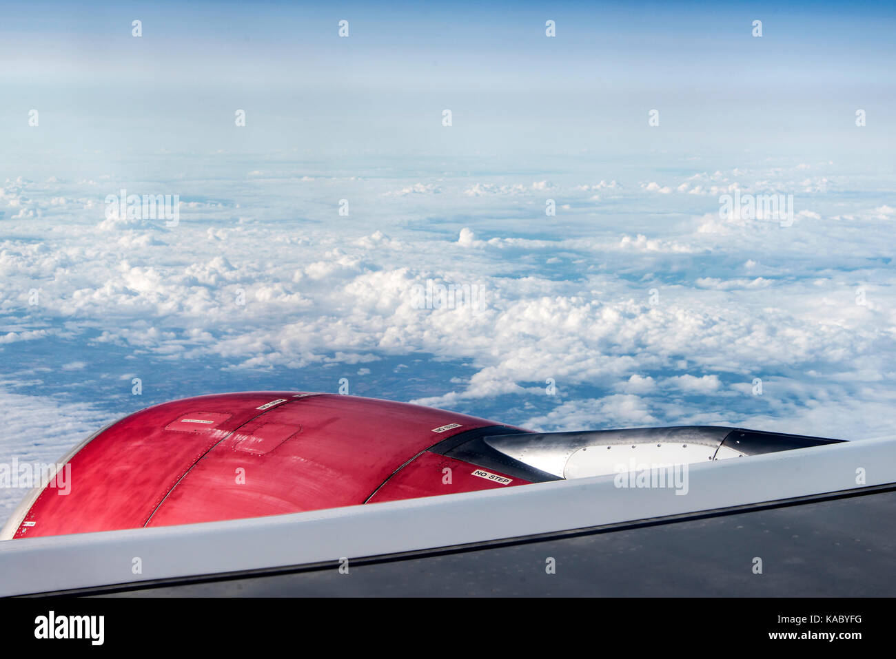 red jet engine turbine look through aircraft window on sunny day blue ...