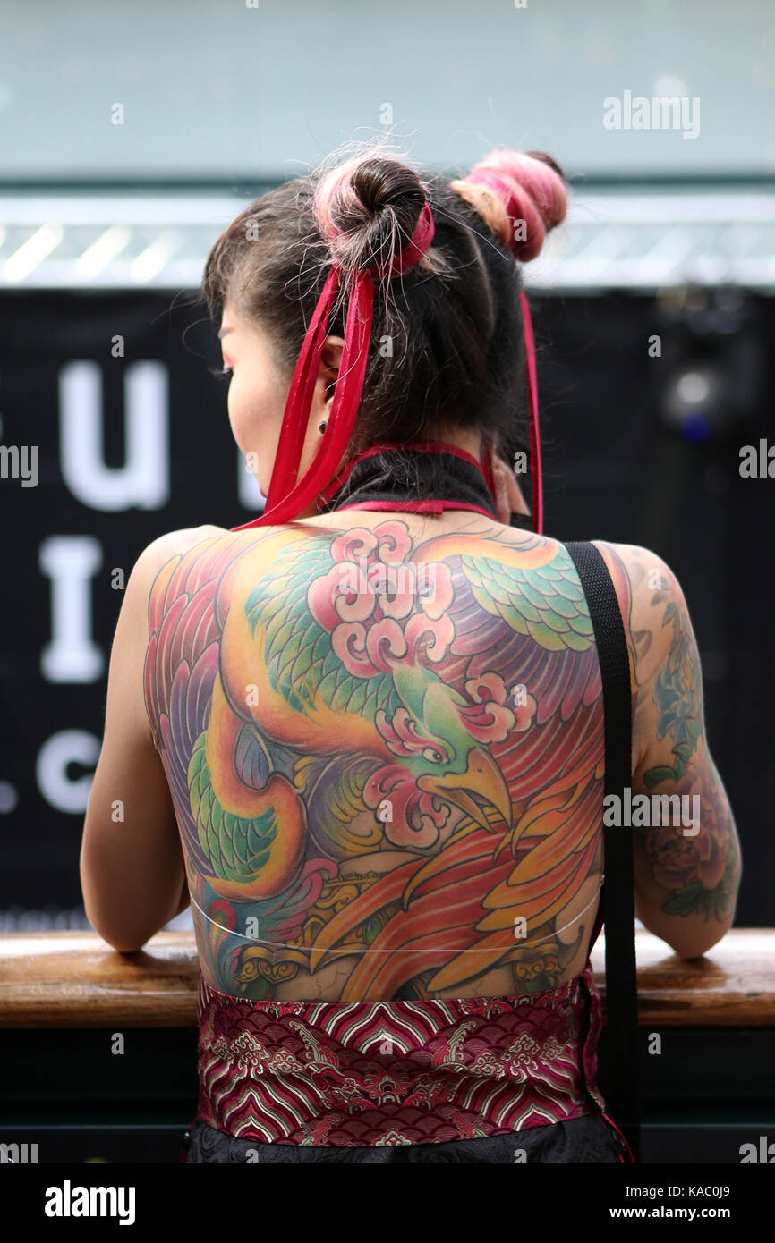 Tattooed back of a woman at The International London Tattoo Convention 2017, Tobacco Dock, London, UK. Stock Photo