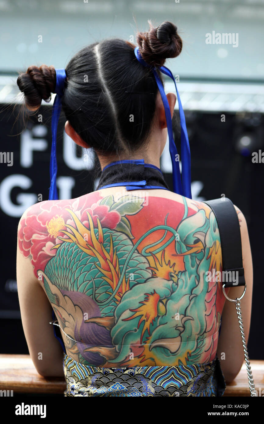 Tattooed back of a woman at The International London Tattoo Convention 2017, Tobacco Dock, London, UK. Stock Photo