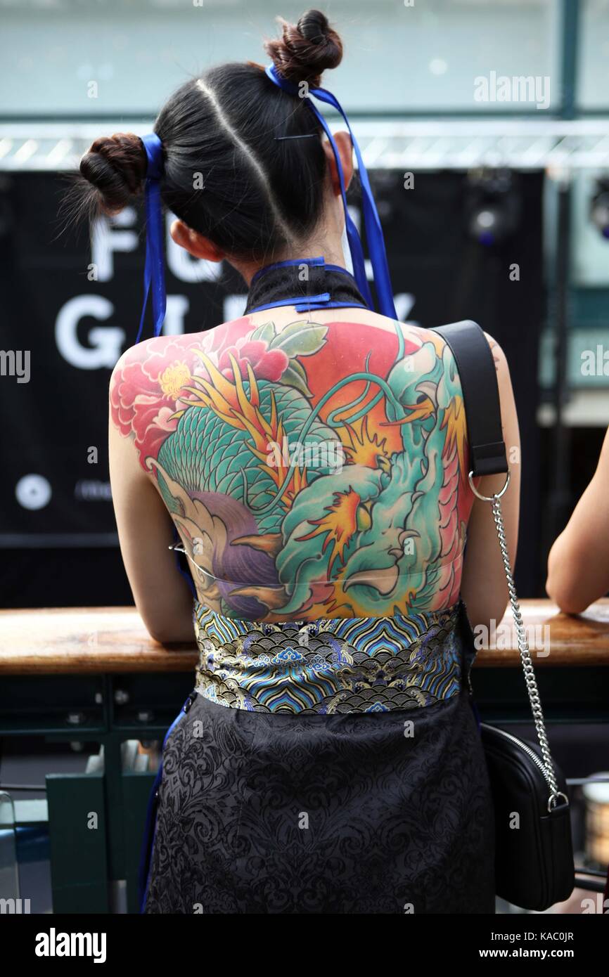 Tattooed back of a woman at The International London Tattoo Convention 2017, Tobacco Dock, London, UK. Stock Photo