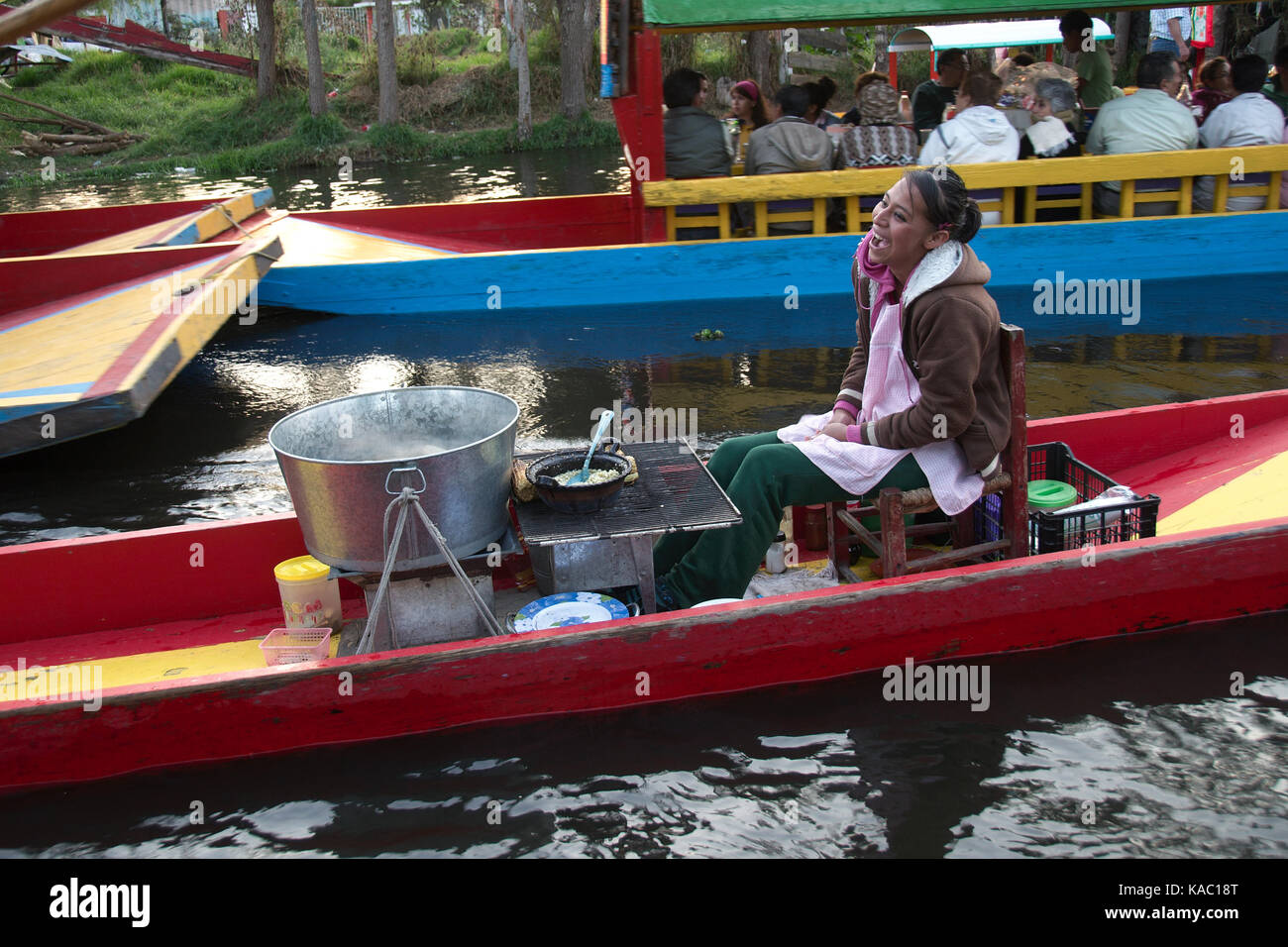 Xochimilco, Mexico City, Mexico - 2016:  A woman sells food on a trajinera boat. Stock Photo