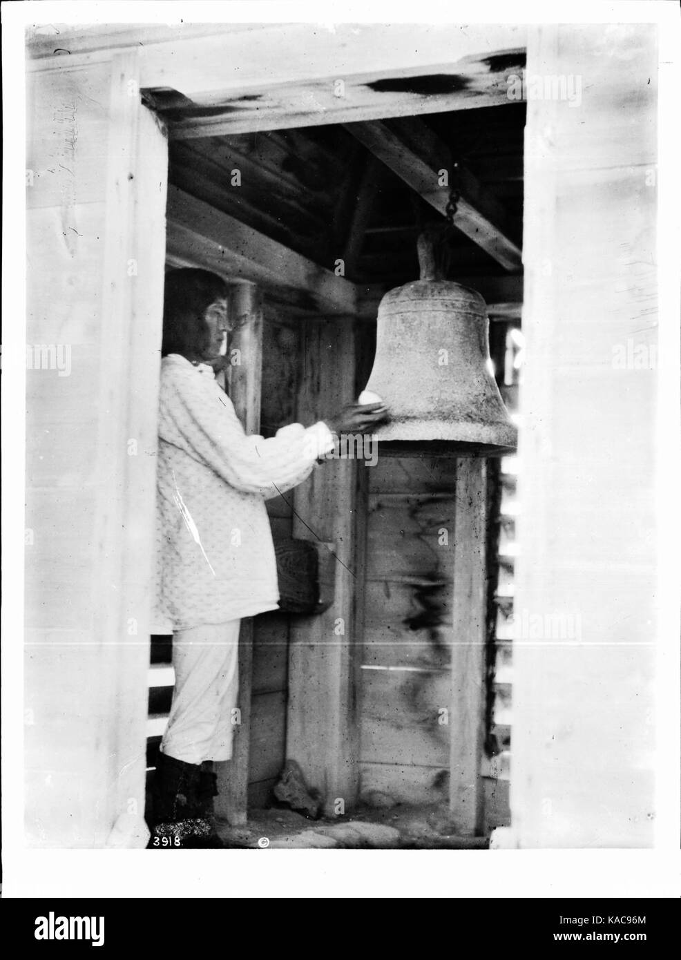 The bell ringer with his bell at the pueblo of Isleta, New Mexico, ca