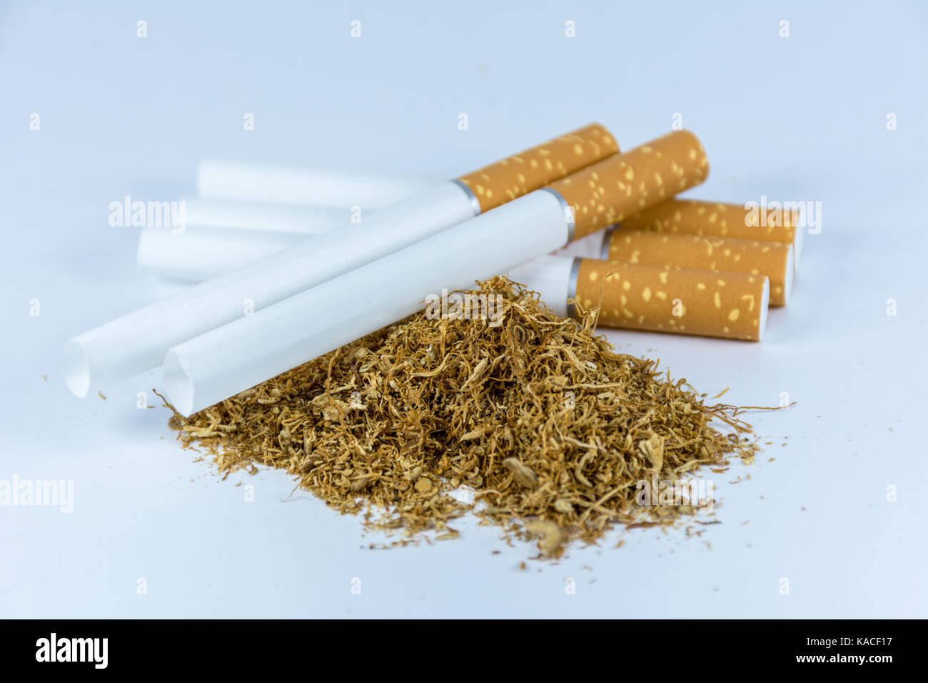 Empty cigarette tubes and tobacco isolated on white background Stock