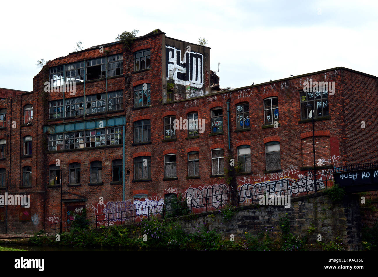 Photo of an abandoned and derelict old mill building in Manchester, UK Stock Photo