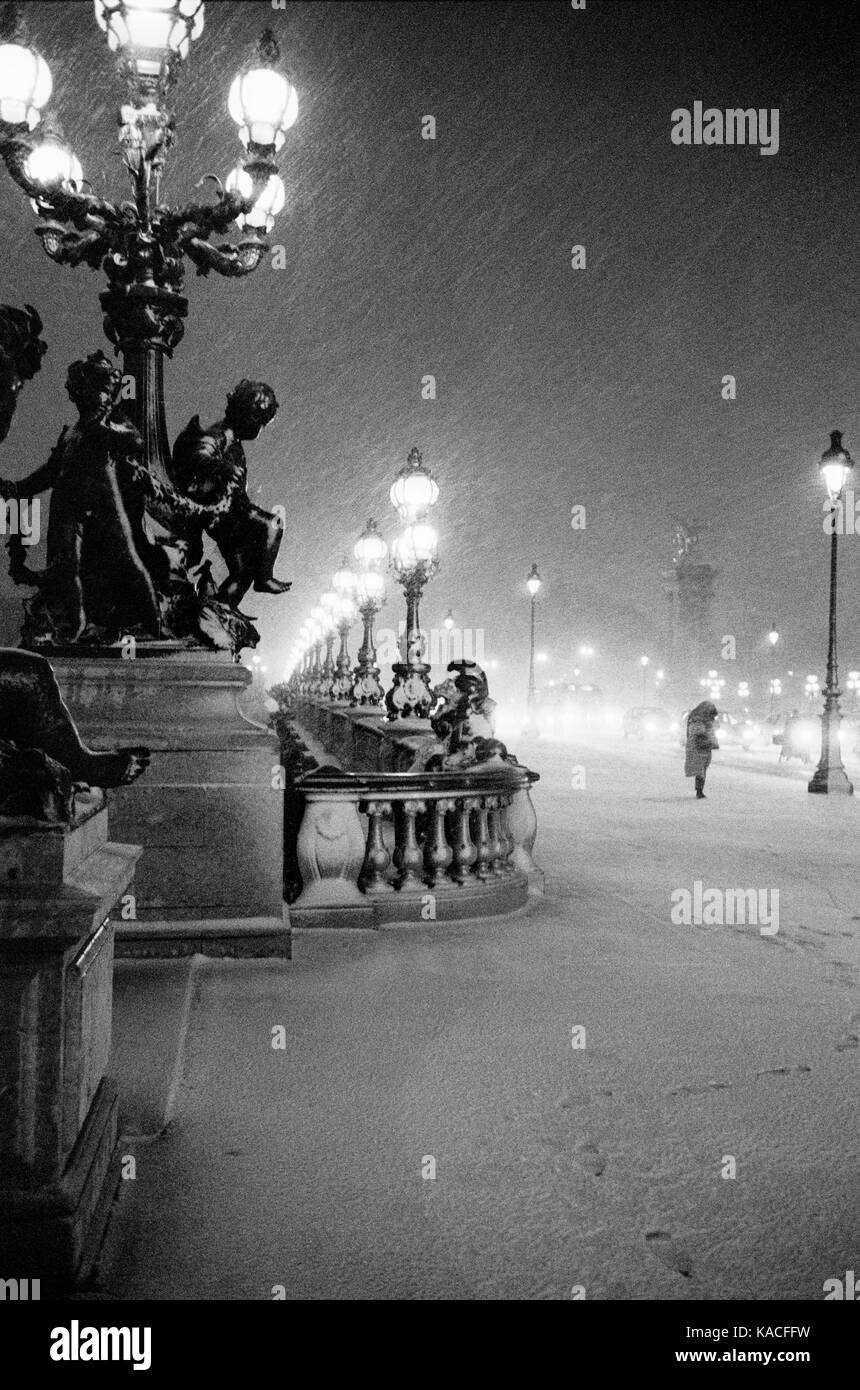 PONT ALEXANDRE III AT NIGHT TIME UNDER A SNOW STORM -  - PARIS WINTER - PARIS FRANCE - LEICA STREET PHOTOGRAPHY - SILVER FILM © Frédéric BEAUMONT Stock Photo