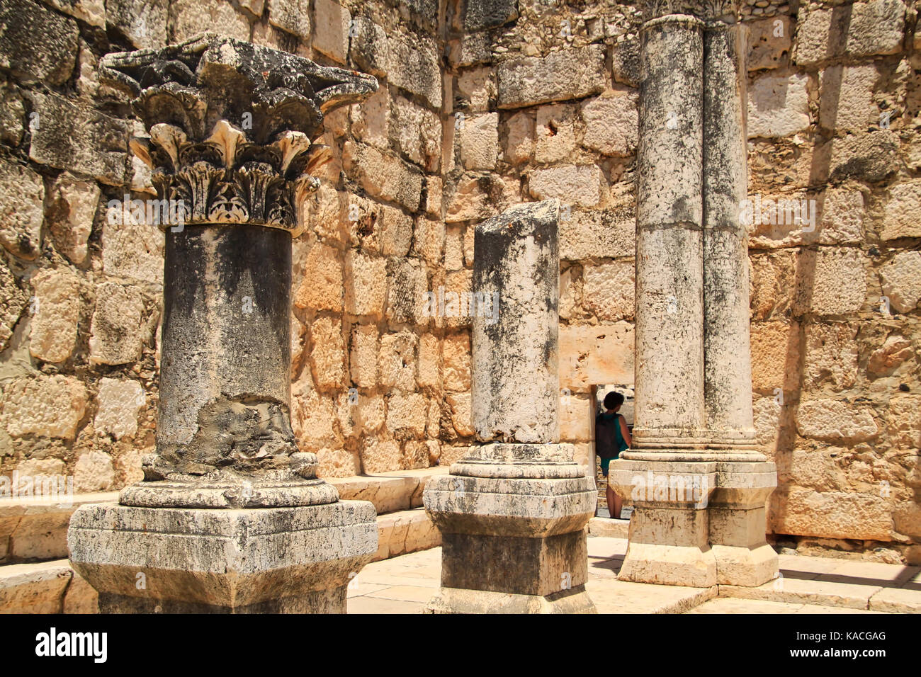Woman leans in doorway of basalt brick wall in the ancient ruins of ...