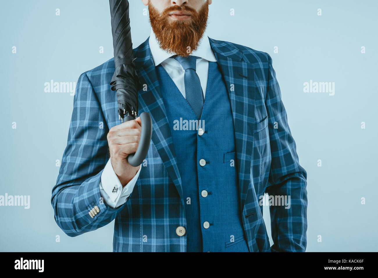 man in suit holding umbrella Stock Photo Alamy