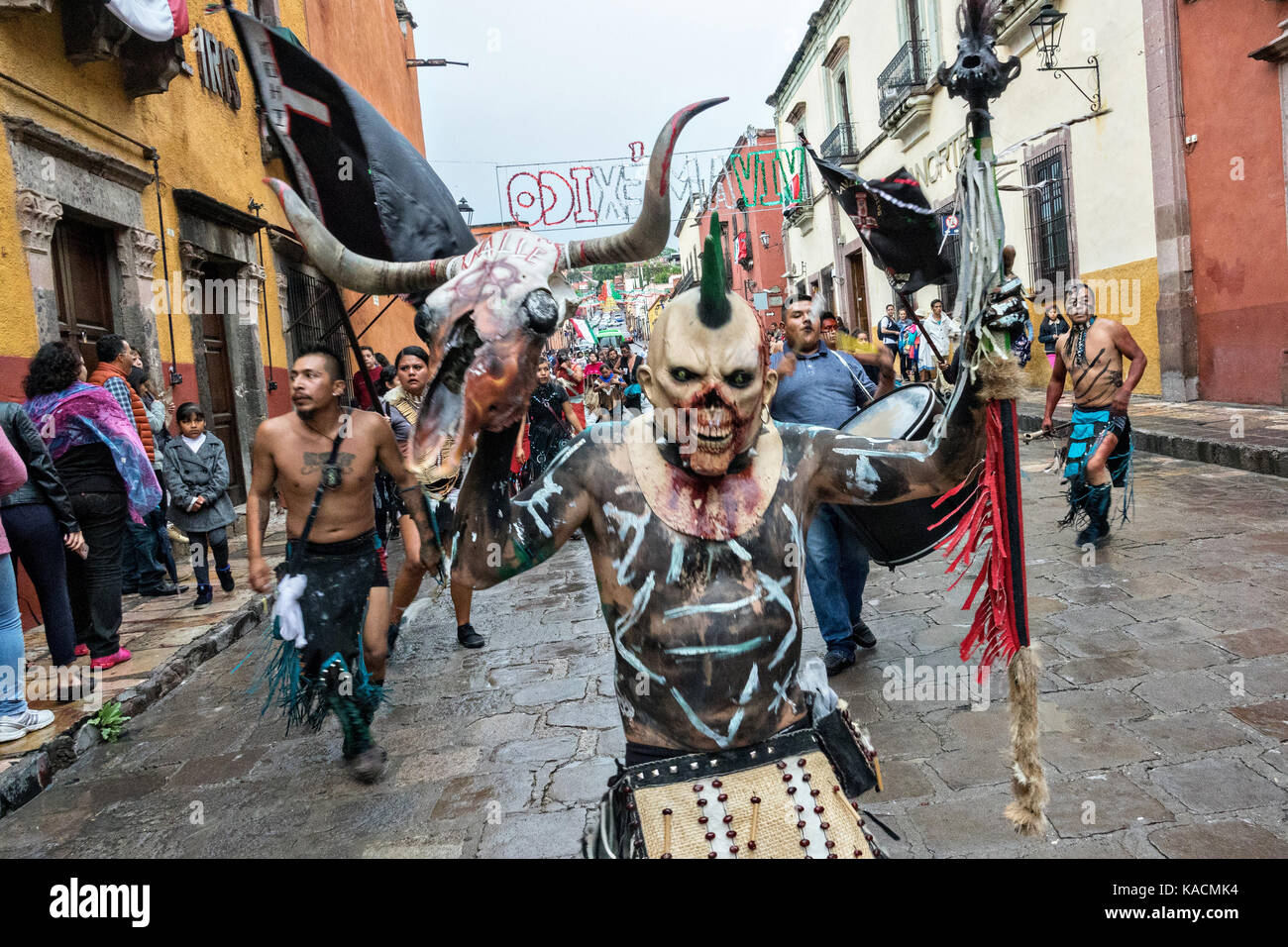 Aztec indians dance in a procession through the historic city during the week long fiesta of the patron saint Saint Michael September 24, 2017 in San Miguel de Allende, Mexico. Stock Photo