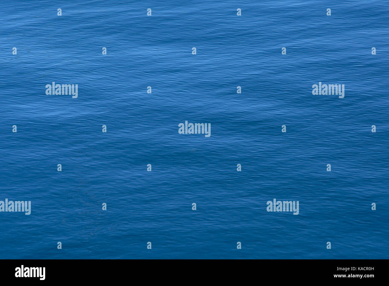 Deep blue calm rippling water background texture Stock Photo - Alamy