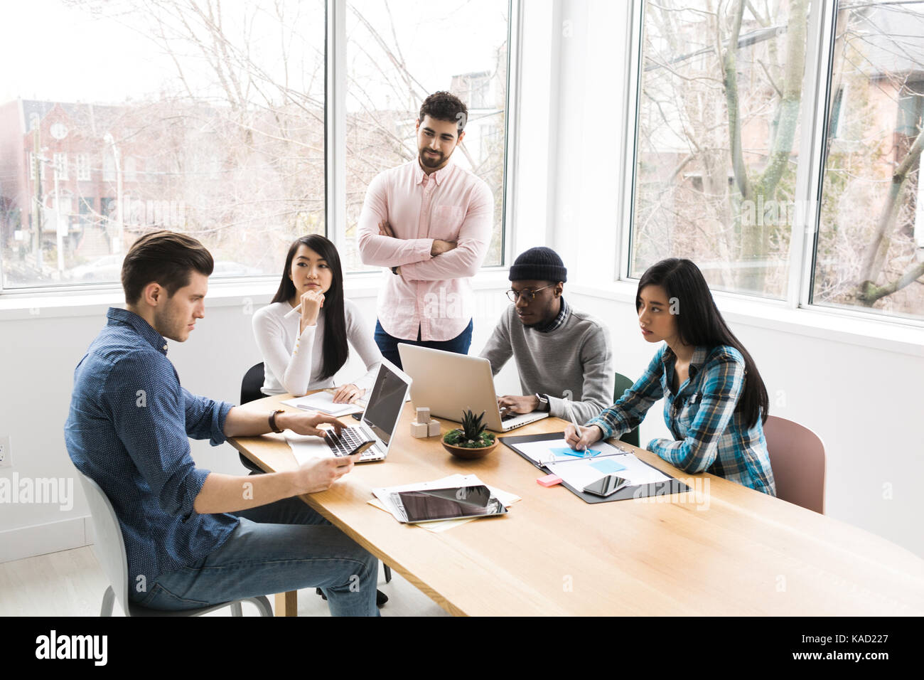 Young business people collaborating Stock Photo - Alamy