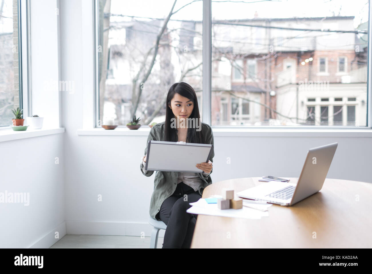 Young Asian businesswoman working on laptop Stock Photo - Alamy