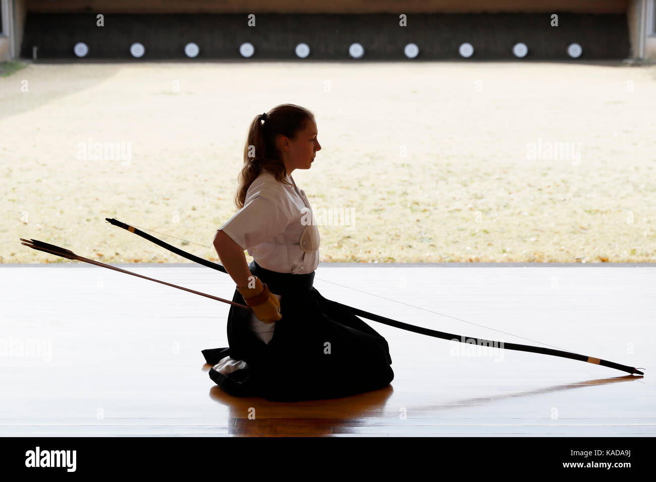 Caucasian woman practicing traditional Kyudo Japanese archery Stock