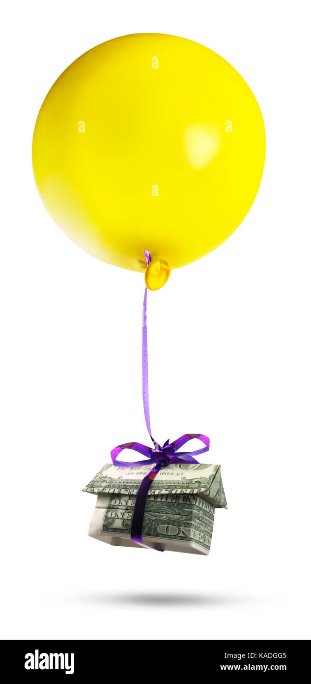 Housing bubble. Isolated origami cash home with a yellow balloon. Stock Photo