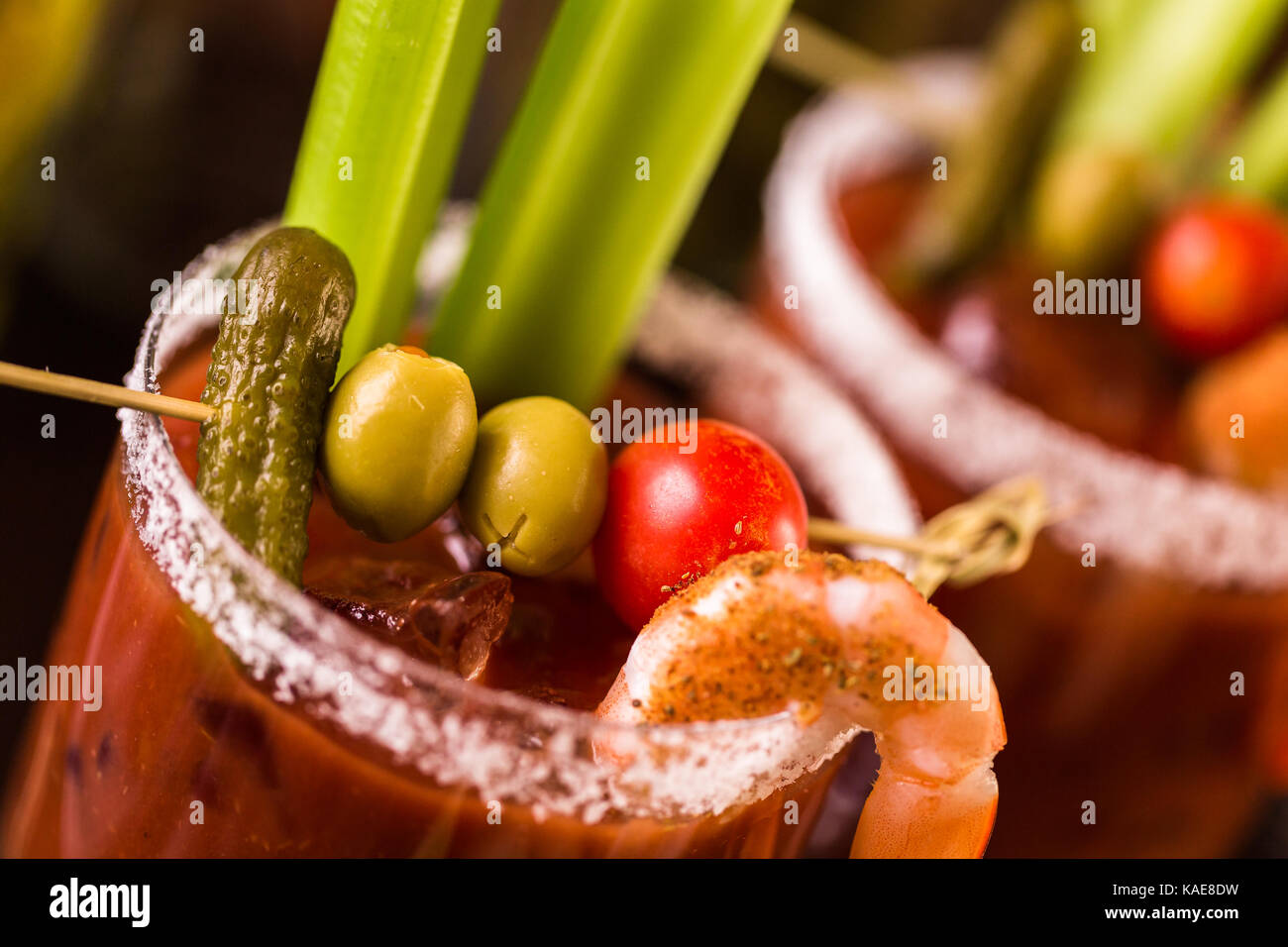 Bloody mary cocktail garnished with celery sticks and olives Stock