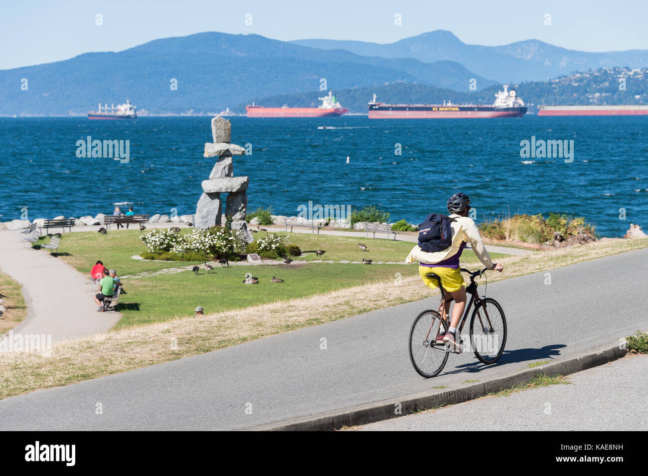 A man is riding a bike on the seawall trail in Vancouver, B.C., Canada