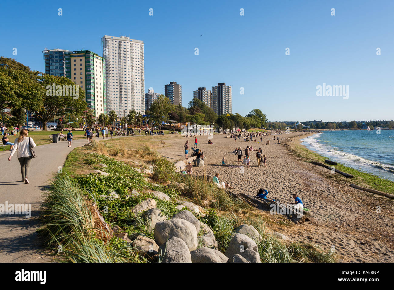 People enjoying a warm and sunny day at Vancouver English Bay beach in summer. Vancouver, British Columbia, Canada - 14 September 2017. Stock Photo