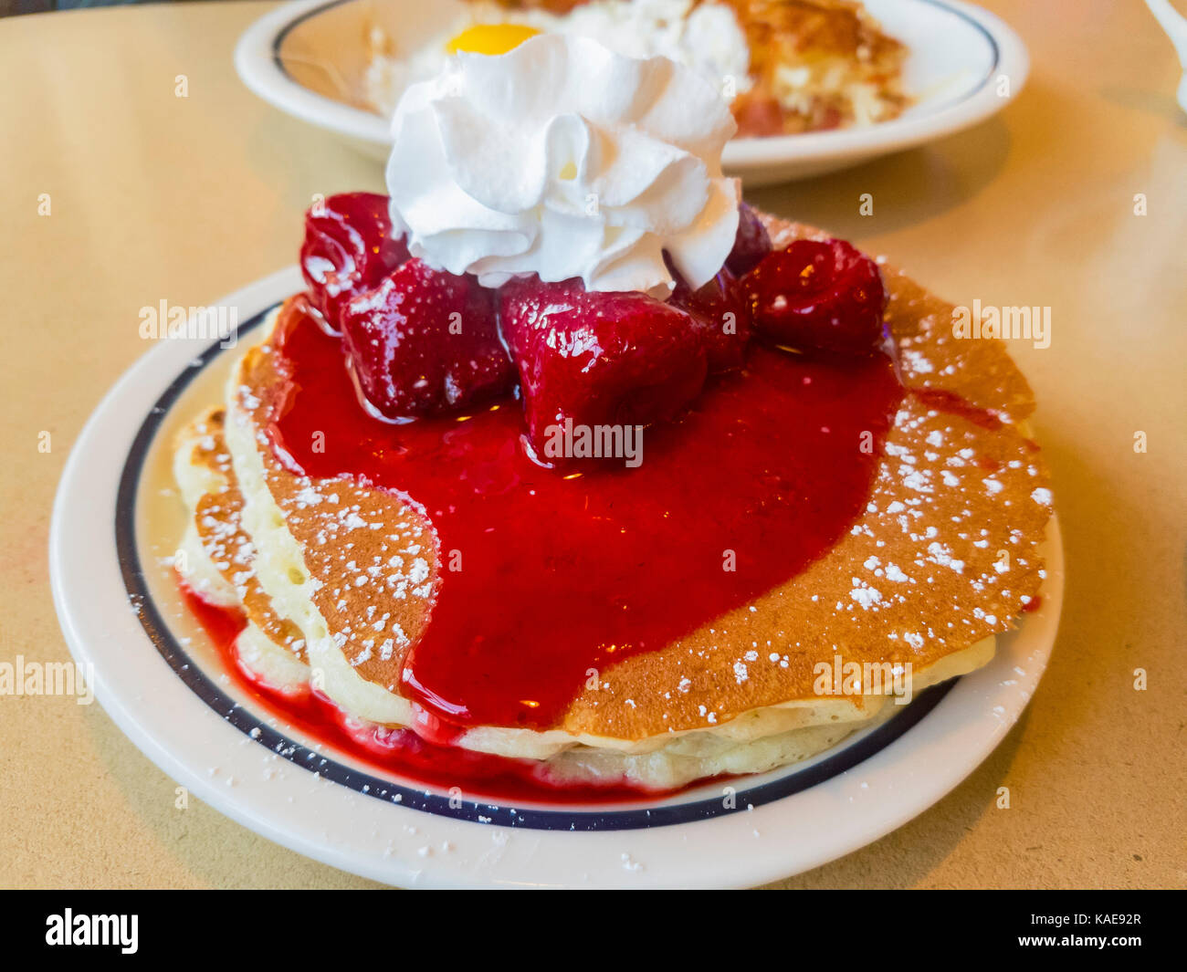 Close up shoot of traidional american breakfast of cream, Strawberry and pancake, photo taken at a chain restaurant, Los Angeles, California, United S Stock Photo