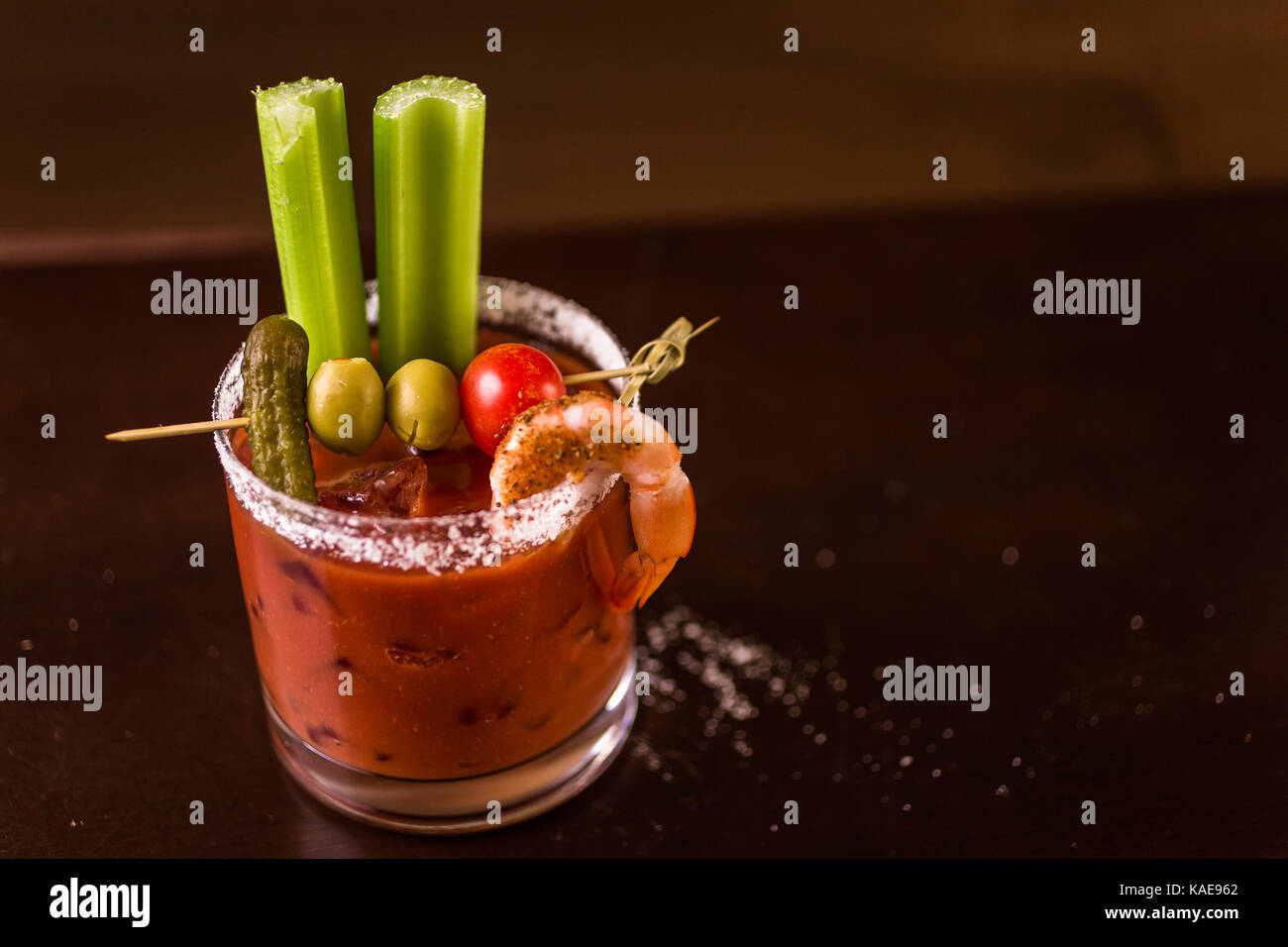 Bloody mary cocktail garnished with celery sticks and olives Stock