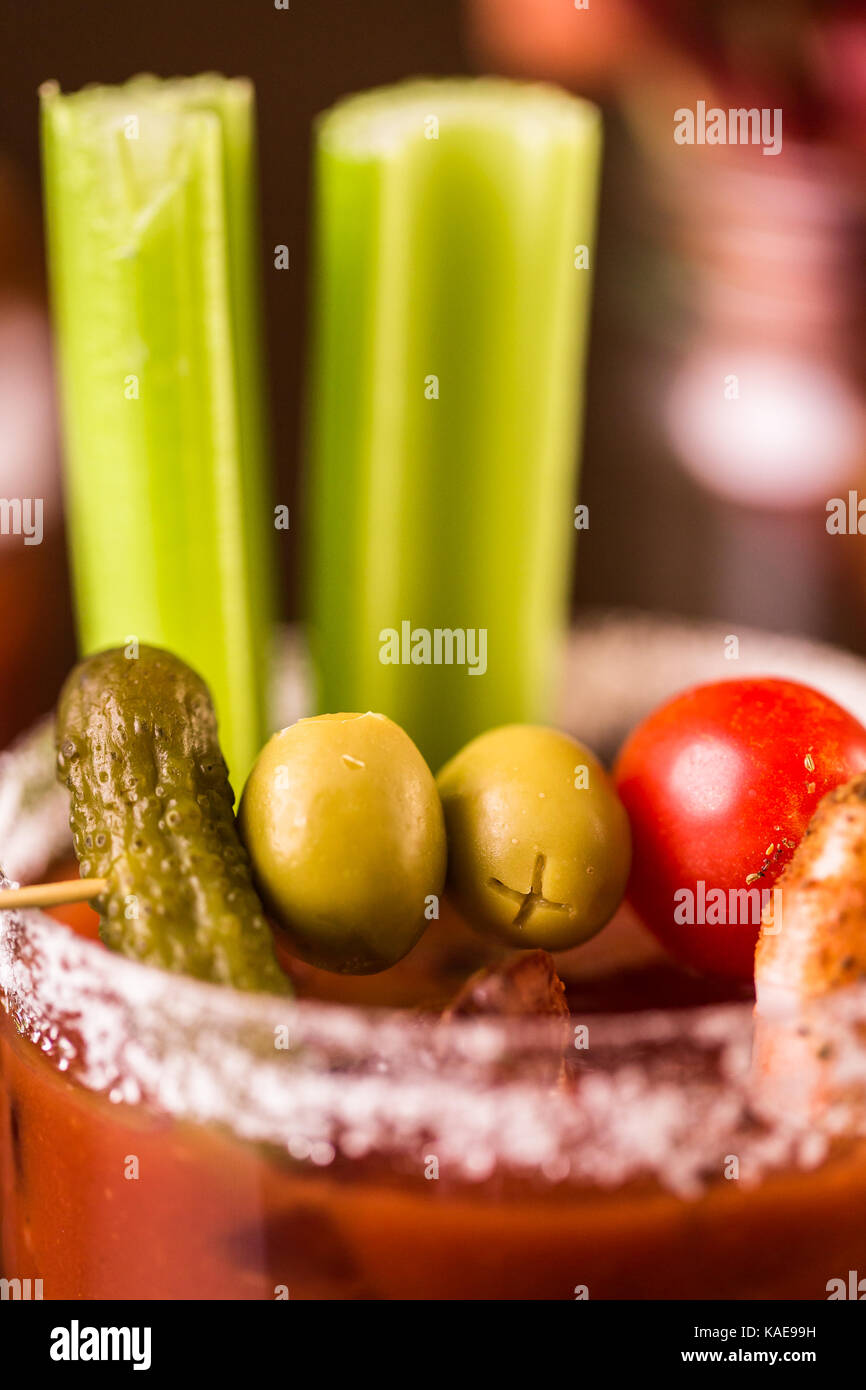 Bloody mary cocktail garnished with celery sticks and olives Stock
