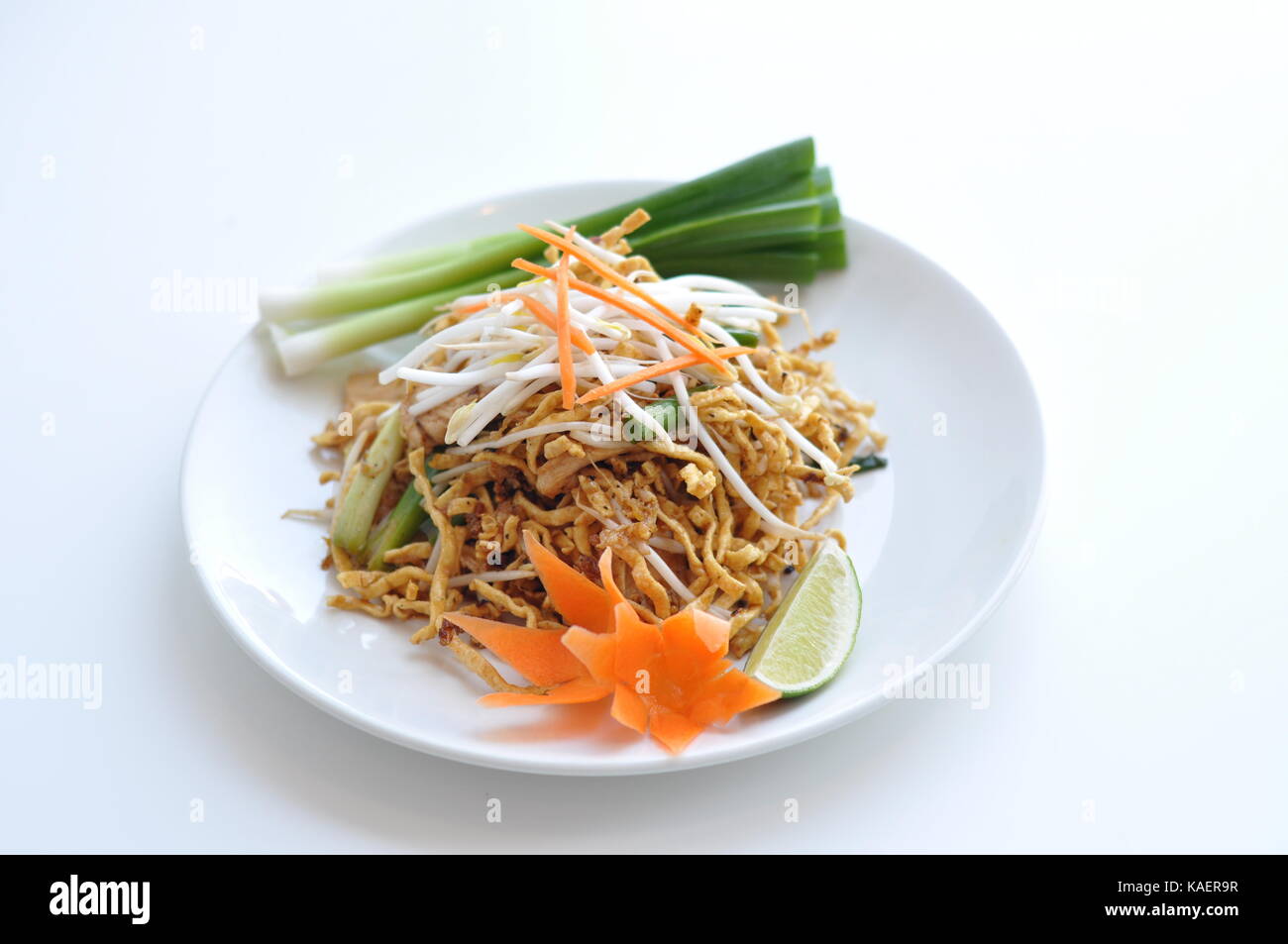Crispy Chicken Pad Thai. Rice noodles stir-fried with egg, scallions, bean sprouts and ground peanuts topped with crispy chicken. Stock Photo