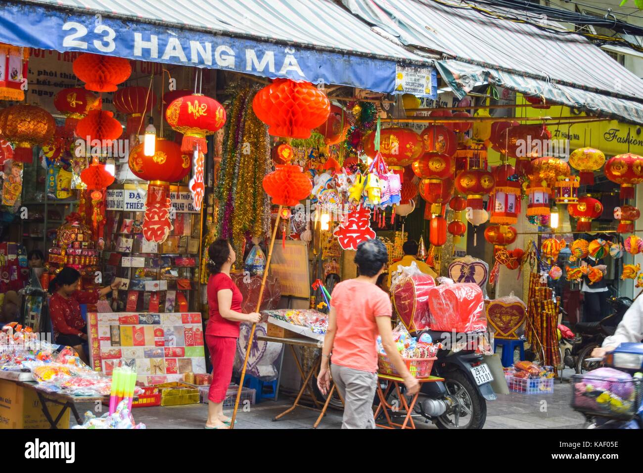 Colorful scene, friendly vendor on Hang Ma lantern street at night ...