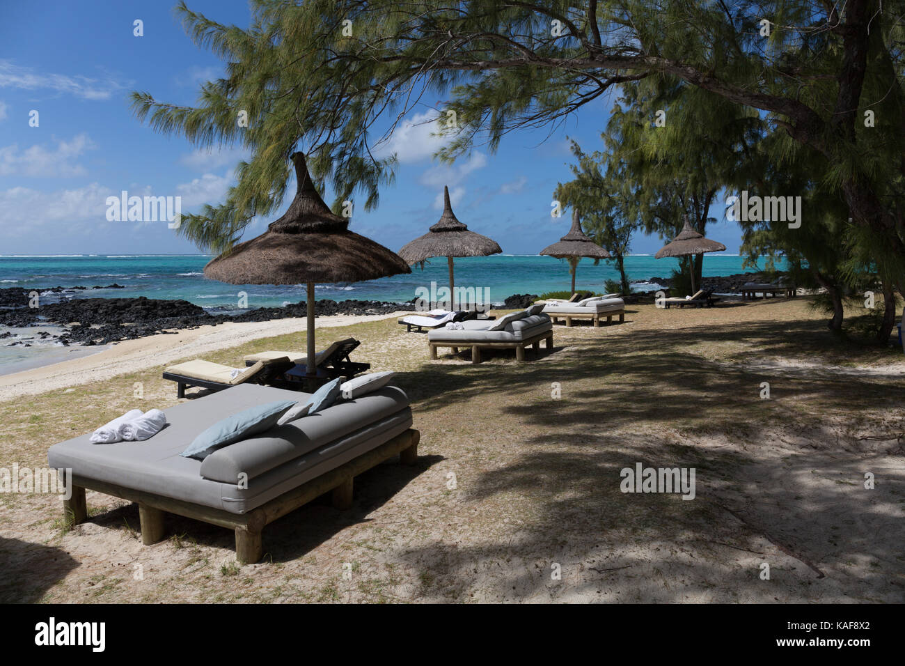 Beach chairs and umbrellas on the Ilot Mangenie Mauritius Stock Photo