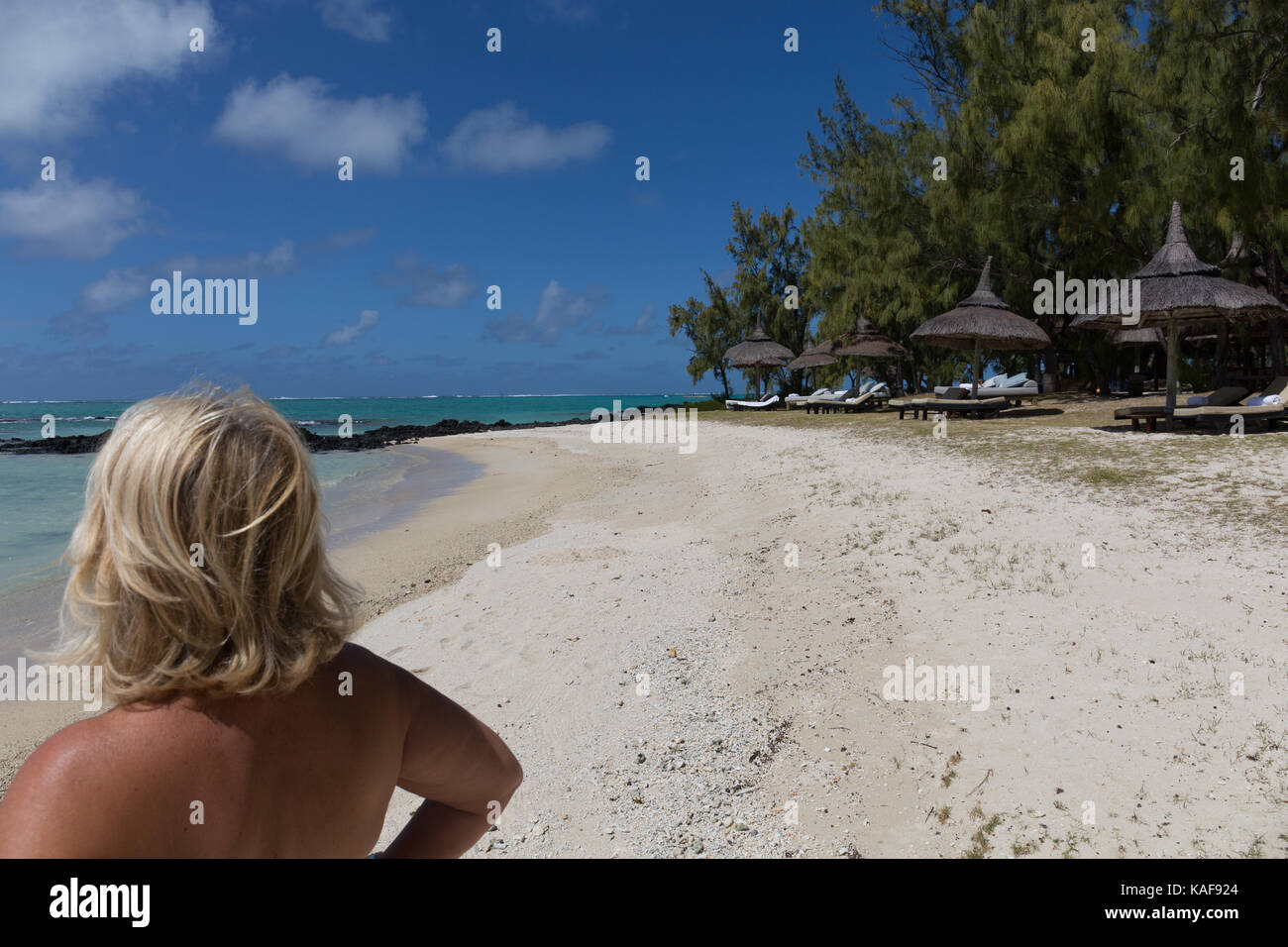 Blonde woman looking at the sea in Mauritius Stock Photo